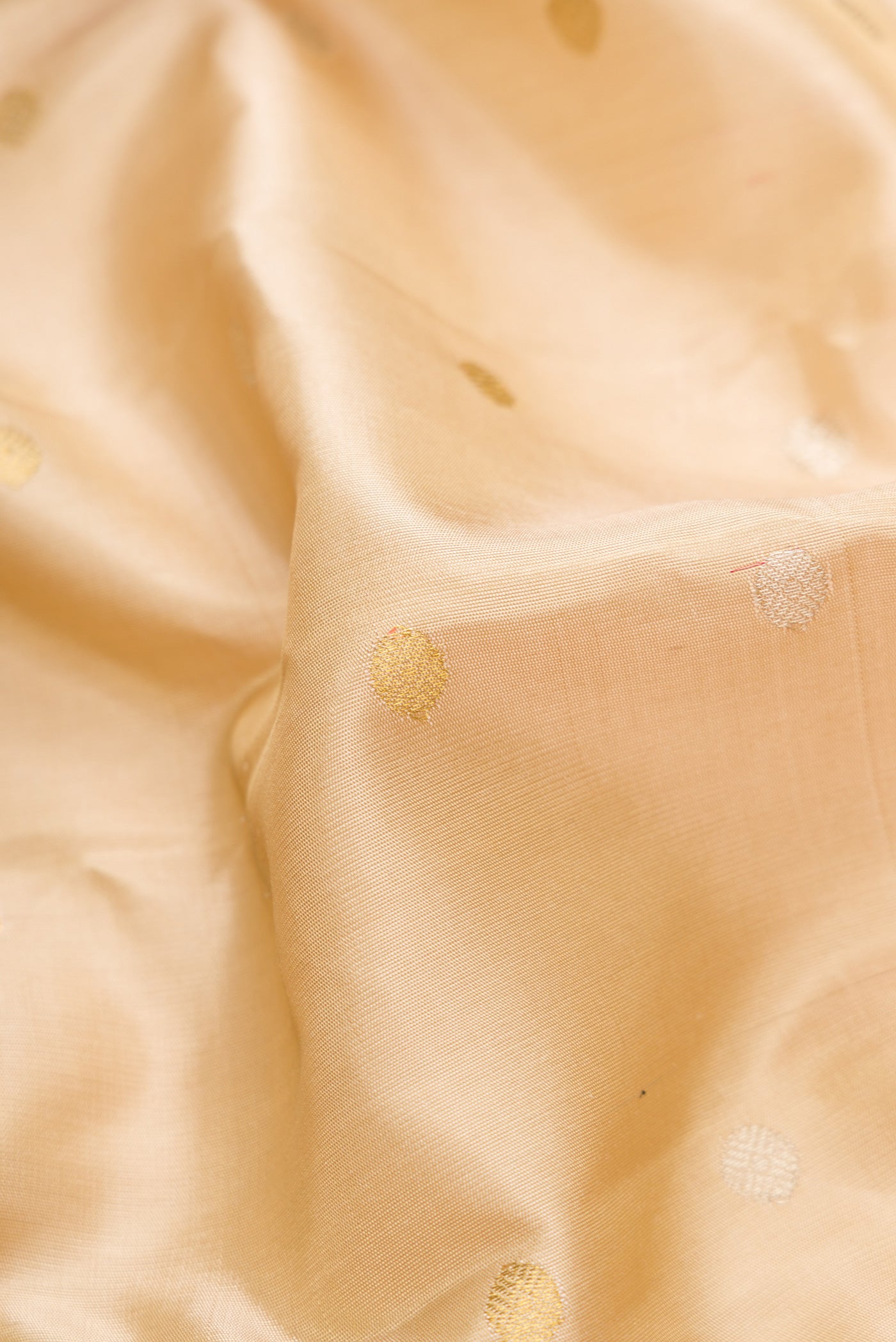 Close up of Beige Dual Tone Gadwal Silk Saree with Zari Butta on the body and Zari Border.  displaying folds