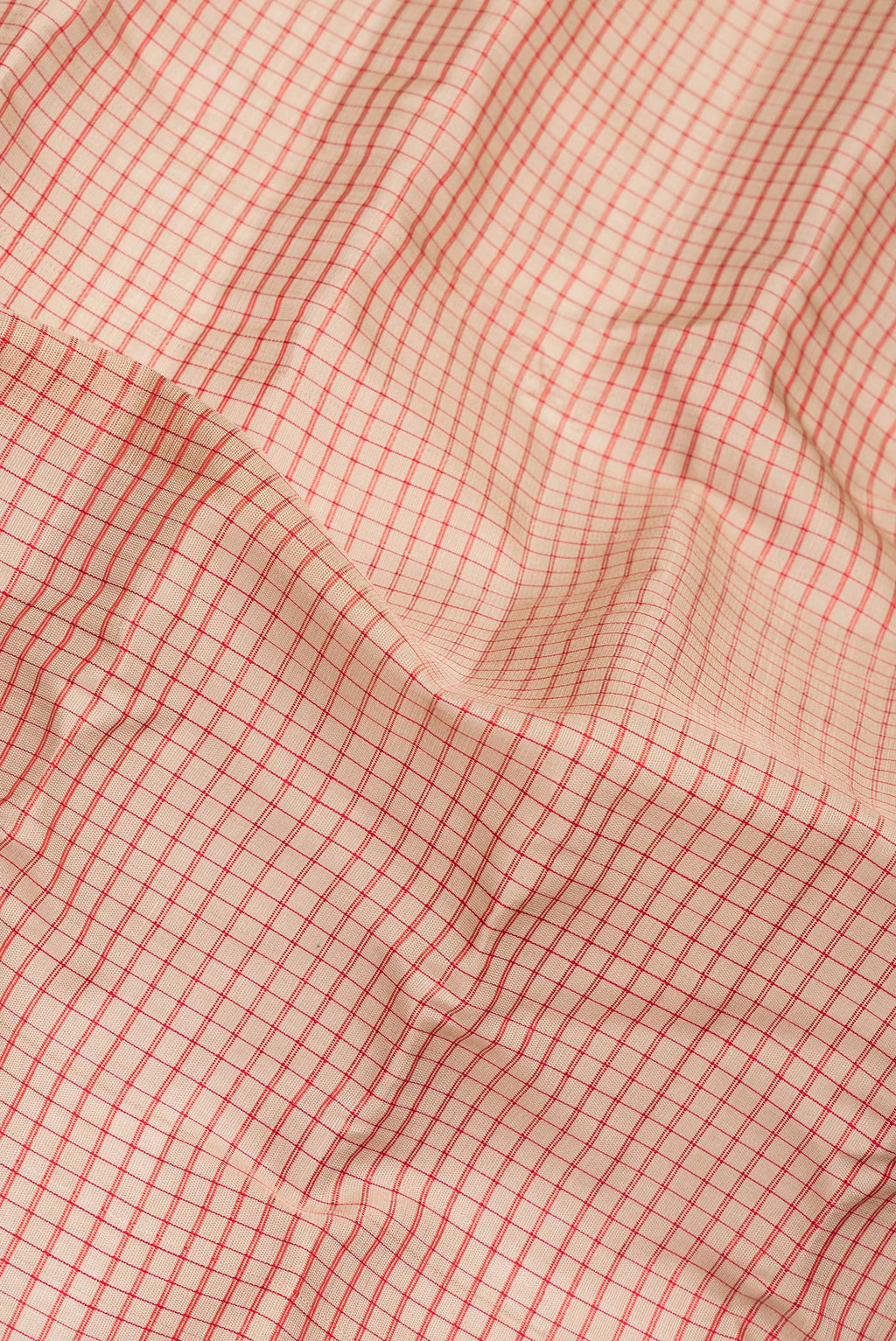 Close up of Pure Silk Dark Beige Dual Tone Gadwal Saree with Checked design on the body and Zari Border.  displaying folds