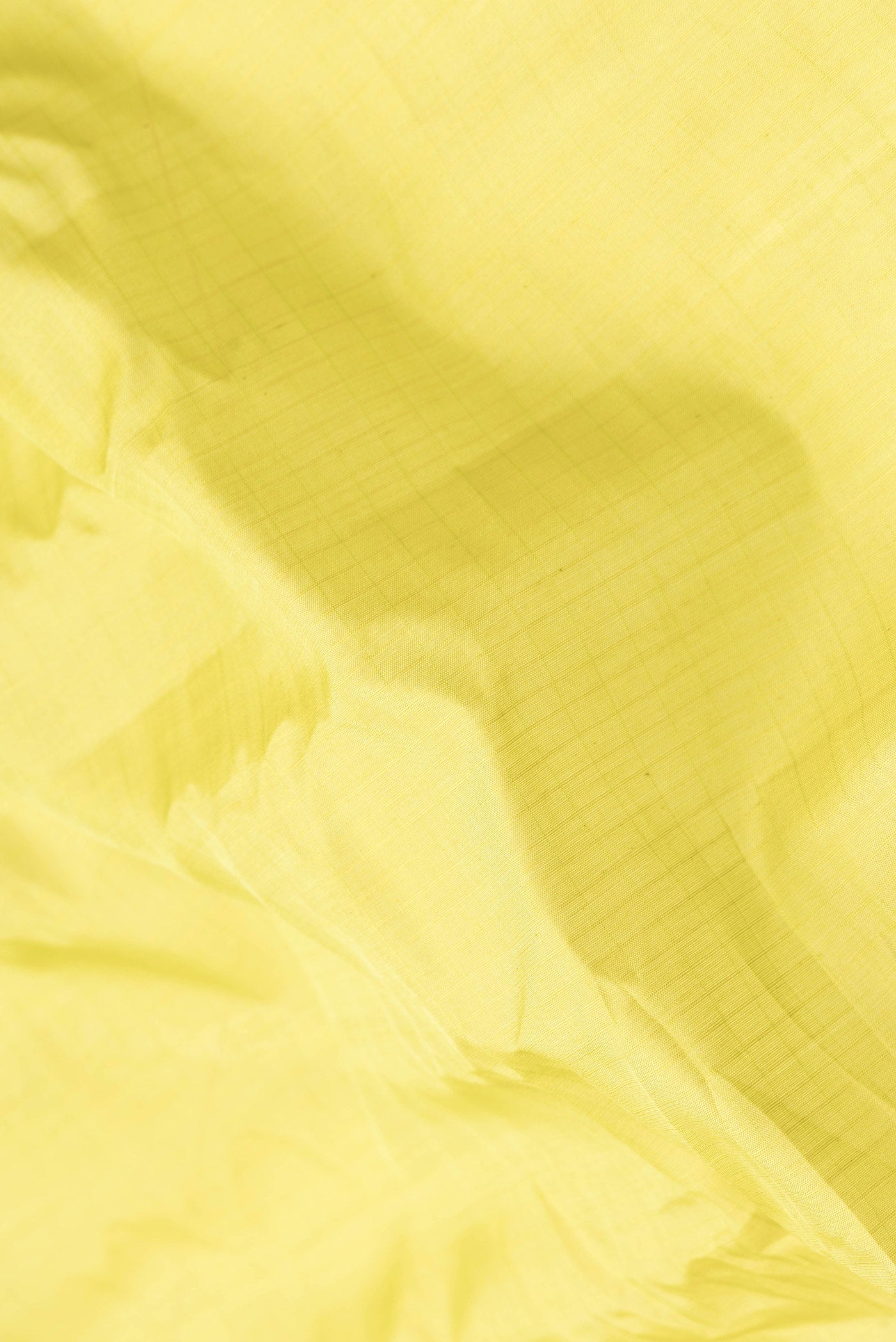 Close up of Parrot Green Dual Tone Gadwal Silk Saree with Checked design on the body and Temple Border.  displaying folds