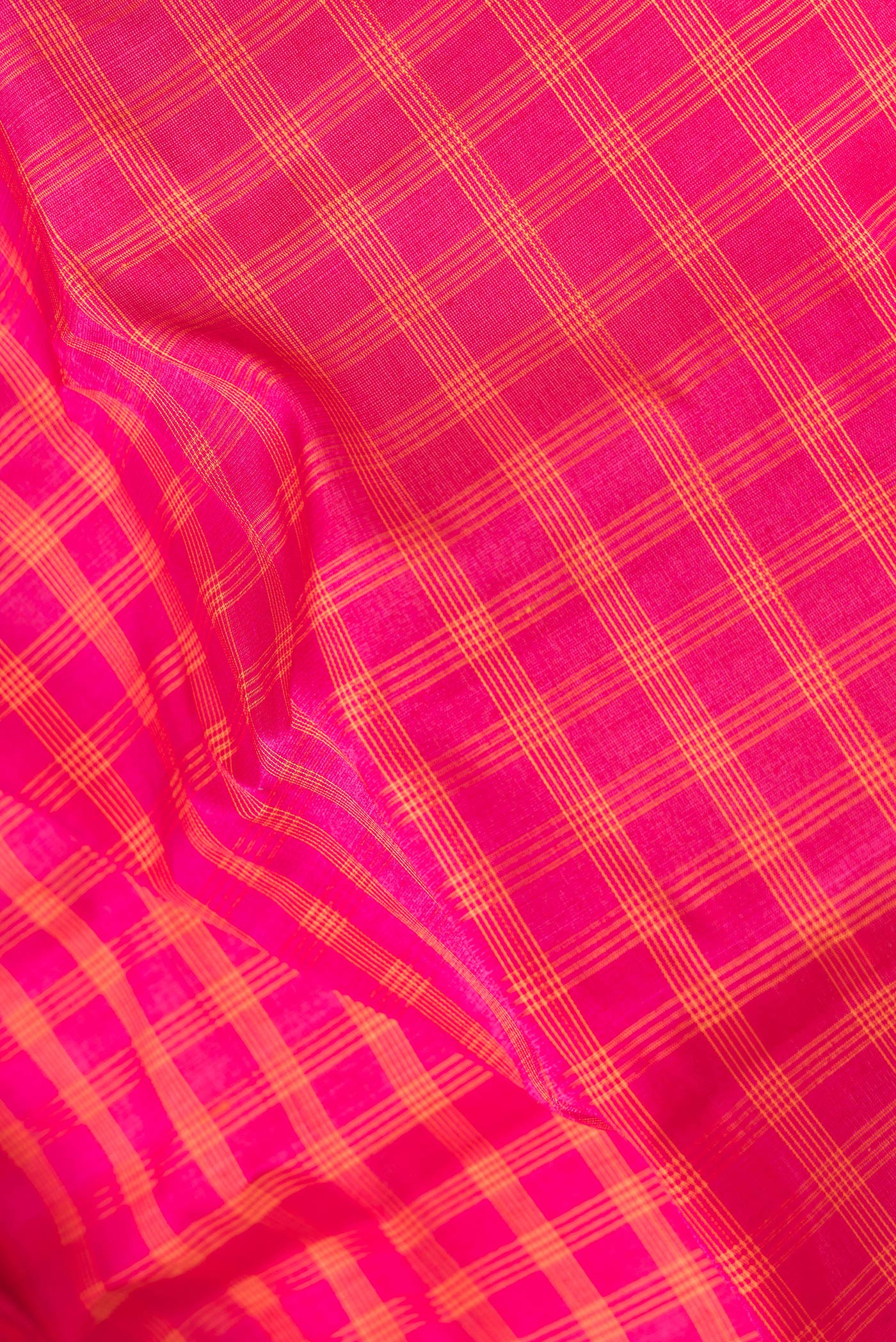 Close up of Magenta Dual Tone Gadwal Silk Saree with Checked design on the body and Zari Border.  displaying folds