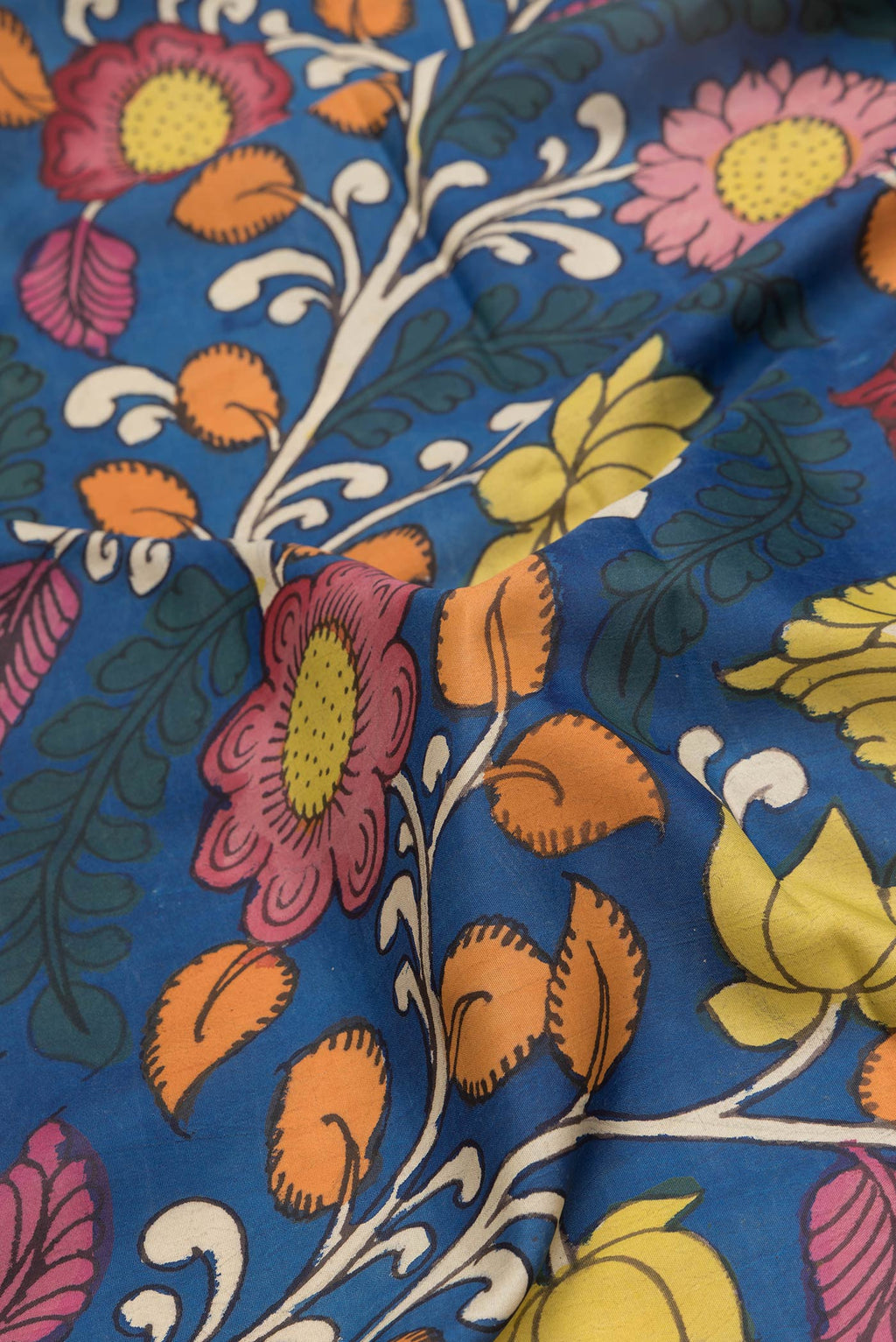 Close up of Peacock Blue Dual Tone Kanchipuram Silk Saree with kalamkari Print on the body and Zari Border.  displaying folds