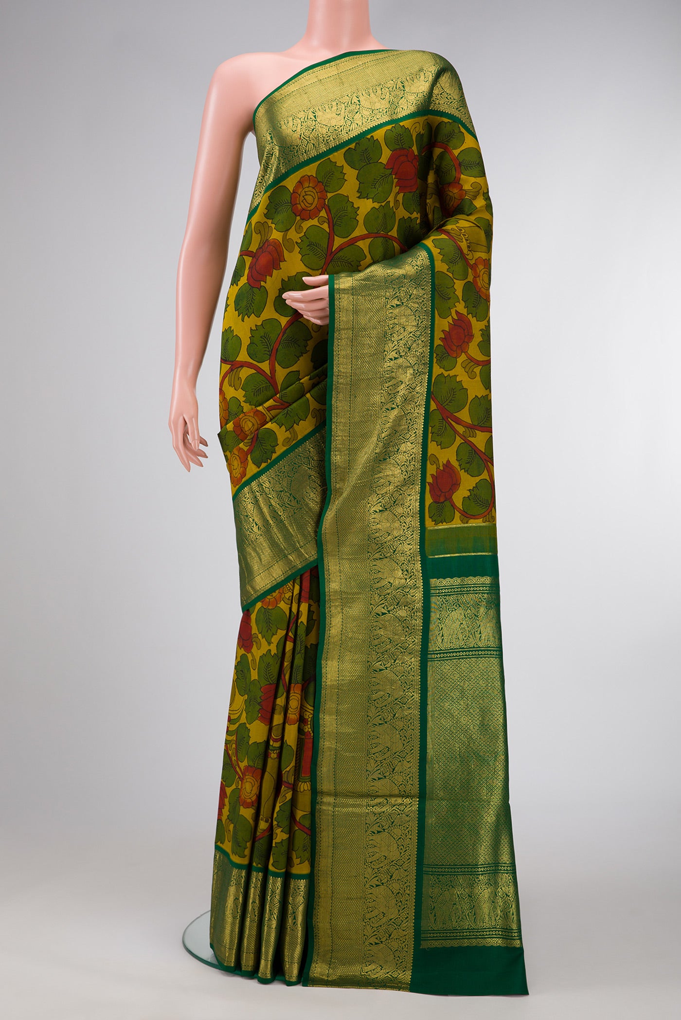 Mehandi Green Dual Tone Kanchipuram Silk Saree with kalamkari Print on the body and Zari Border.  displayed on a mannequin