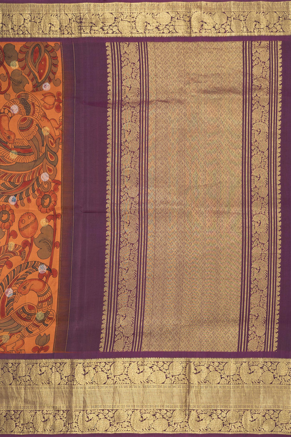 Close up image of the pallu of Orange Dual Tone Kanchipuram Silk Saree with kalamkari Print on the body and Zari Border. 