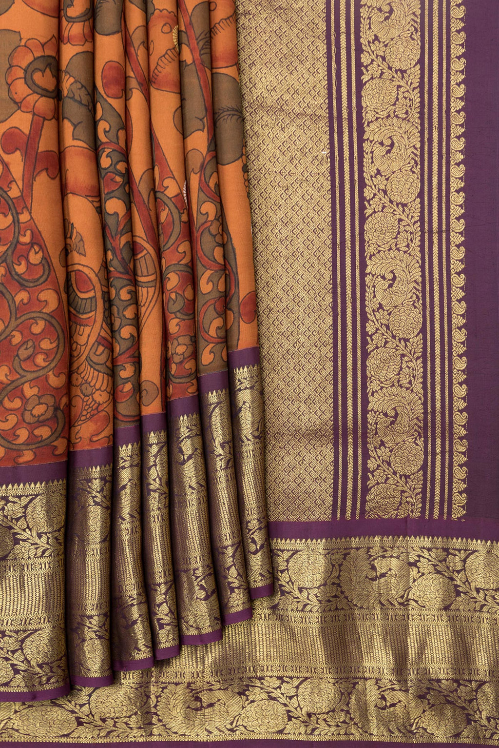 Pleats and pallu of Orange Dual Tone Kanchipuram Silk Saree with kalamkari Print on the body and Zari Border. 