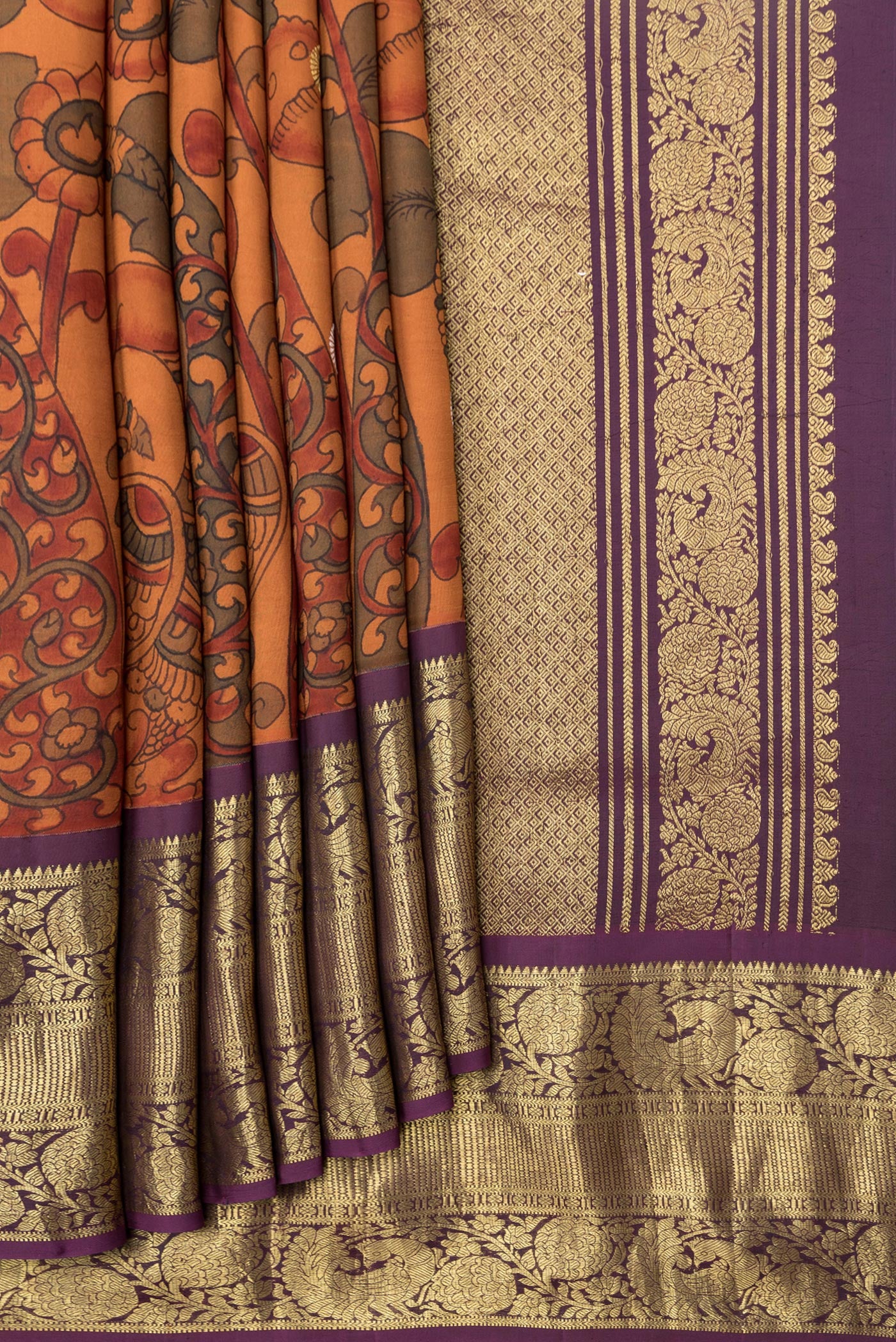 Pleats and pallu of Orange Dual Tone Kanchipuram Silk Saree with kalamkari Print on the body and Zari Border. 