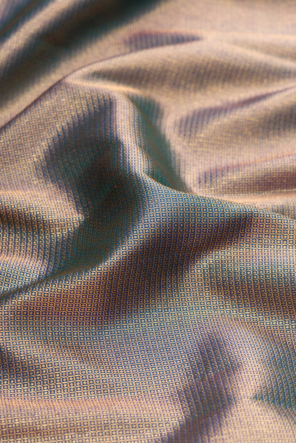 Close up of Peacock Blue Dual Tone Kanjivaram Silk Saree with Zari Brocade on the body and Fancy Border.  displaying folds