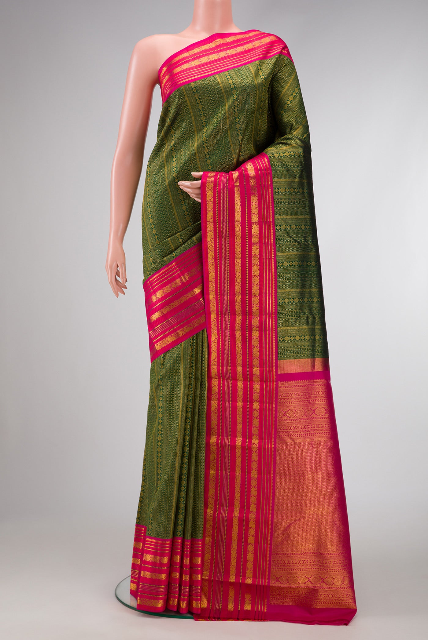 Bottle Green Dual Tone Kanjivaram Silk Saree with Zari Brocade on the body and Zari Border.  displayed on a mannequin