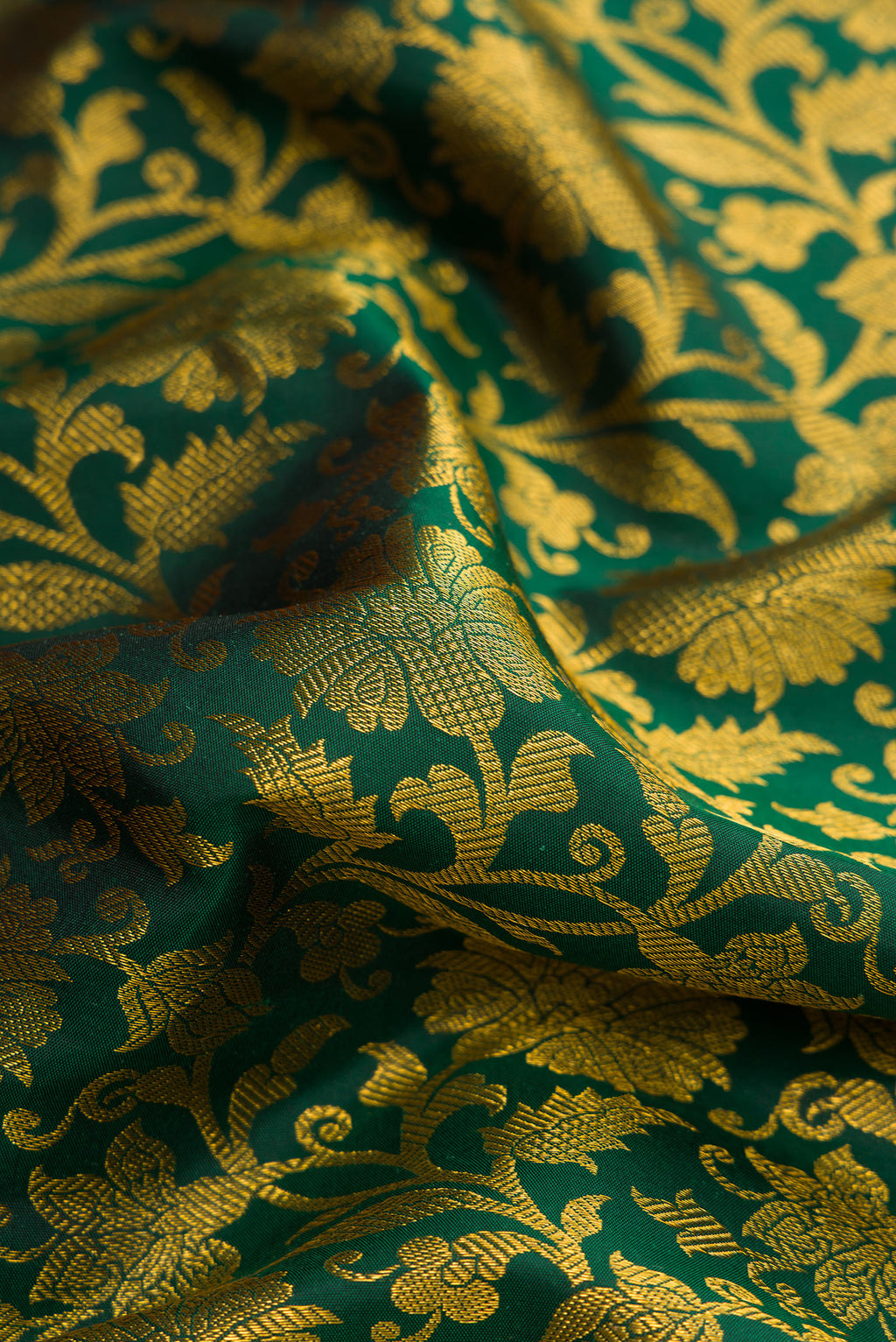 Close up of Bottle Green Dual Tone Kanjivaram Silk Saree with Zari Brocade on the body and Zari Border.  displaying folds