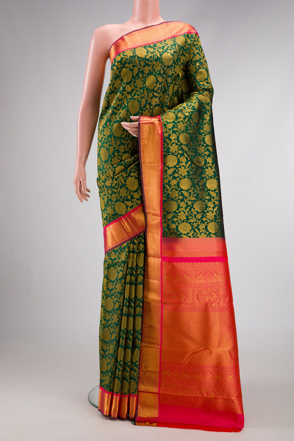 Bottle Green Dual Tone Kanjivaram Silk Saree with Zari Brocade on the body and Zari Border.  displayed on a mannequin