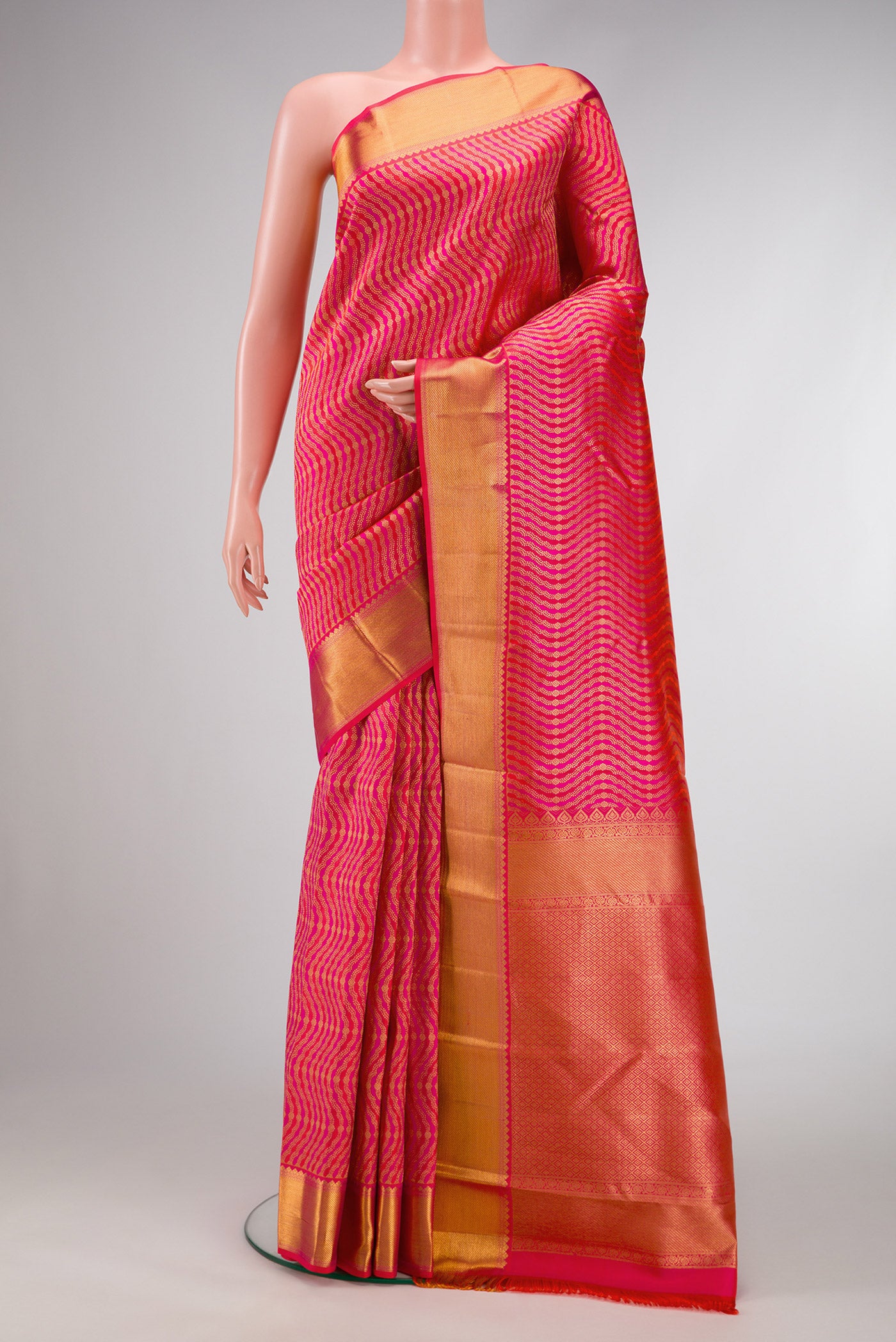 Pink Dual Tone Kanjivaram Silk Saree with Zari Brocade on the body and Zari Border.  displayed on a mannequin