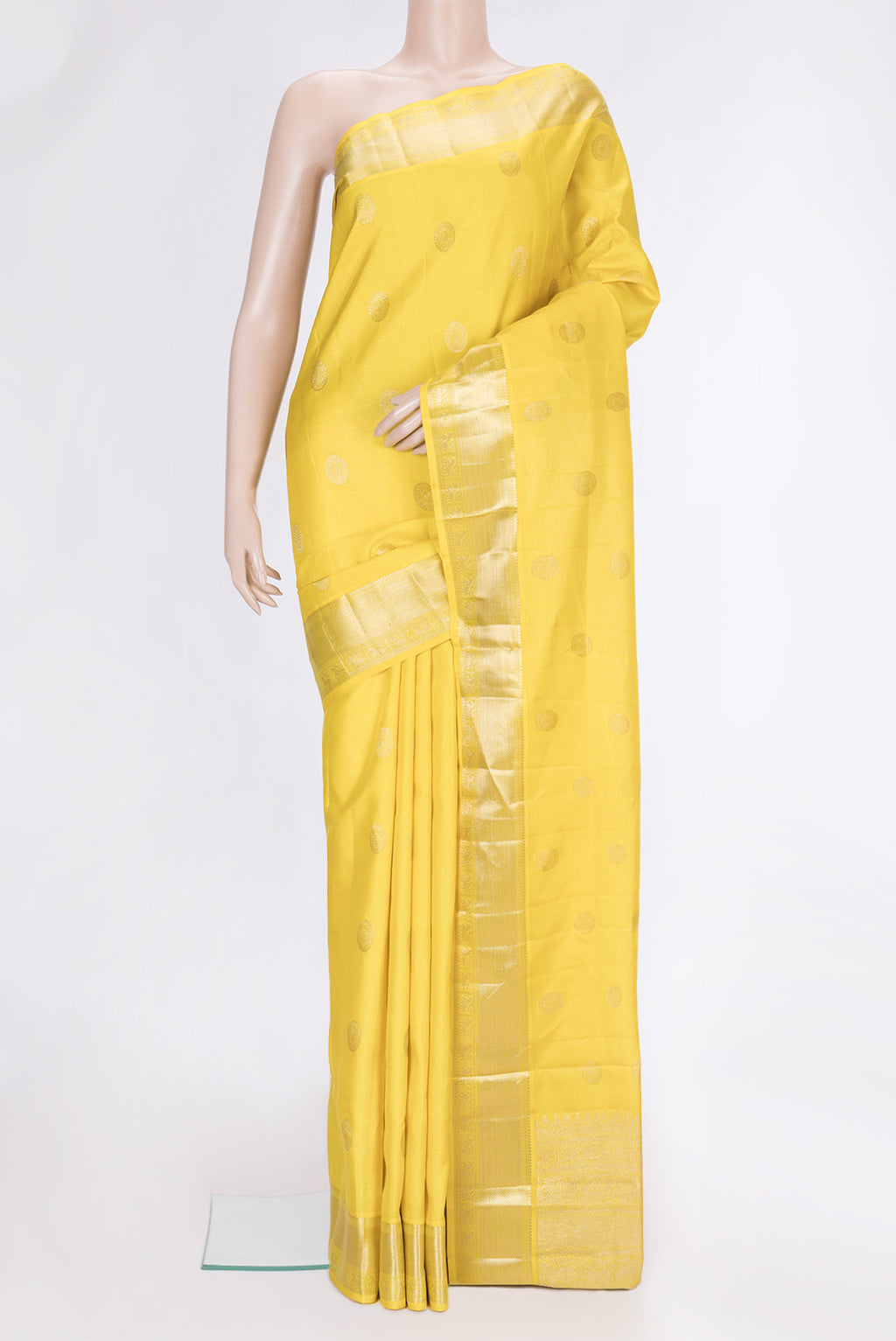 Yellow Dual Tone Kanchipuram Silk Saree with Zari Butta on the body and Zari Border.  displayed on a mannequin