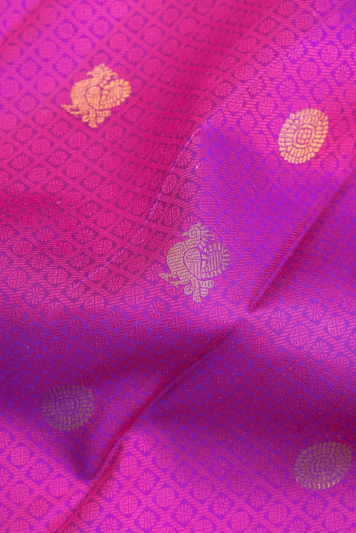Close up of Pure Silk Magenta Kanchipuram Saree with Jacquard With Thread Butta on the body and Zari Border.  displaying folds