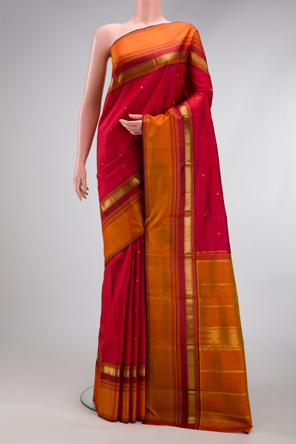 Red Kanchipuram Silk Saree with Zari Butta on the body and Zari Border.  displayed on a mannequin