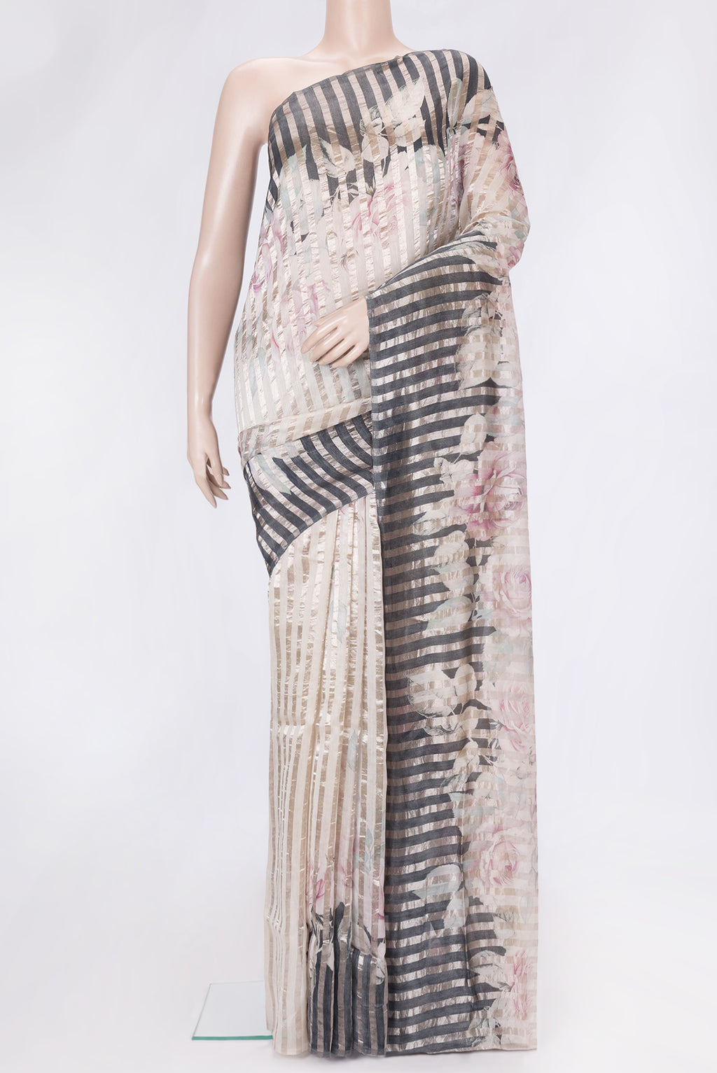 Beige Dual Tone Organza Silk Saree with Stripes on the body and Without Border.  displayed on a mannequin