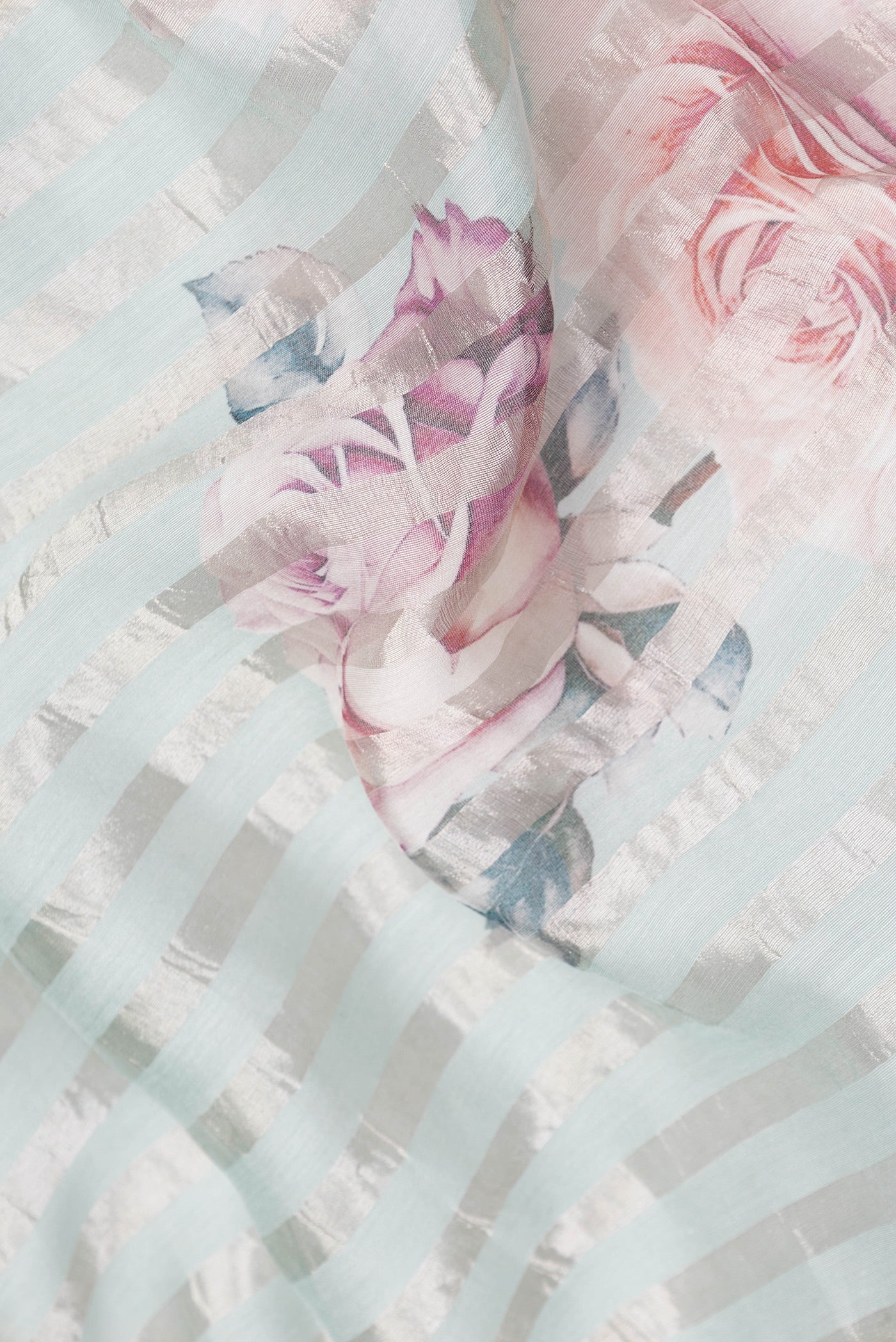 Close up of Sky Blue Dual Tone Organza Silk Saree with Stripes on the body and Fancy Border.  displaying folds