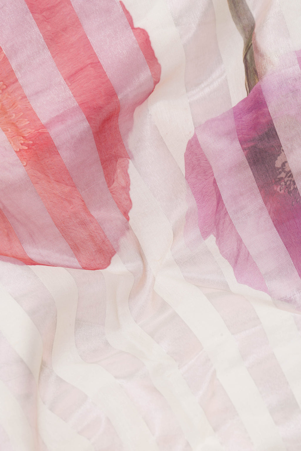 Close up of Beige Dual Tone Organza Silk Saree with Printed design on the body and Without Border.  displaying folds