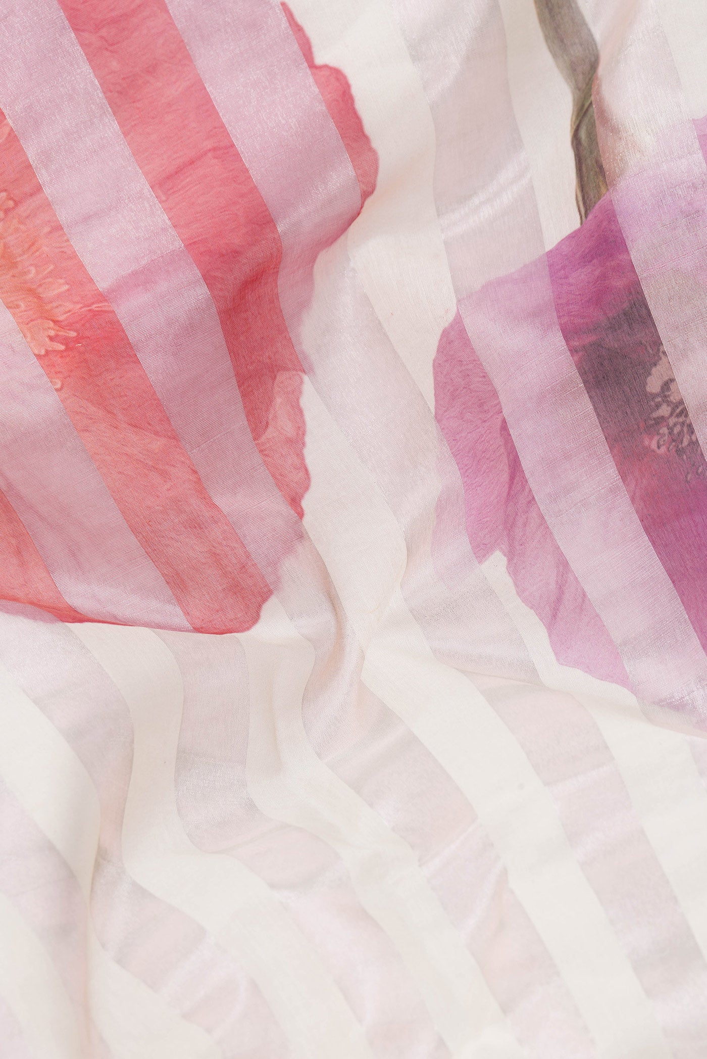 Close up of Beige Dual Tone Organza Silk Saree with Printed design on the body and Without Border.  displaying folds