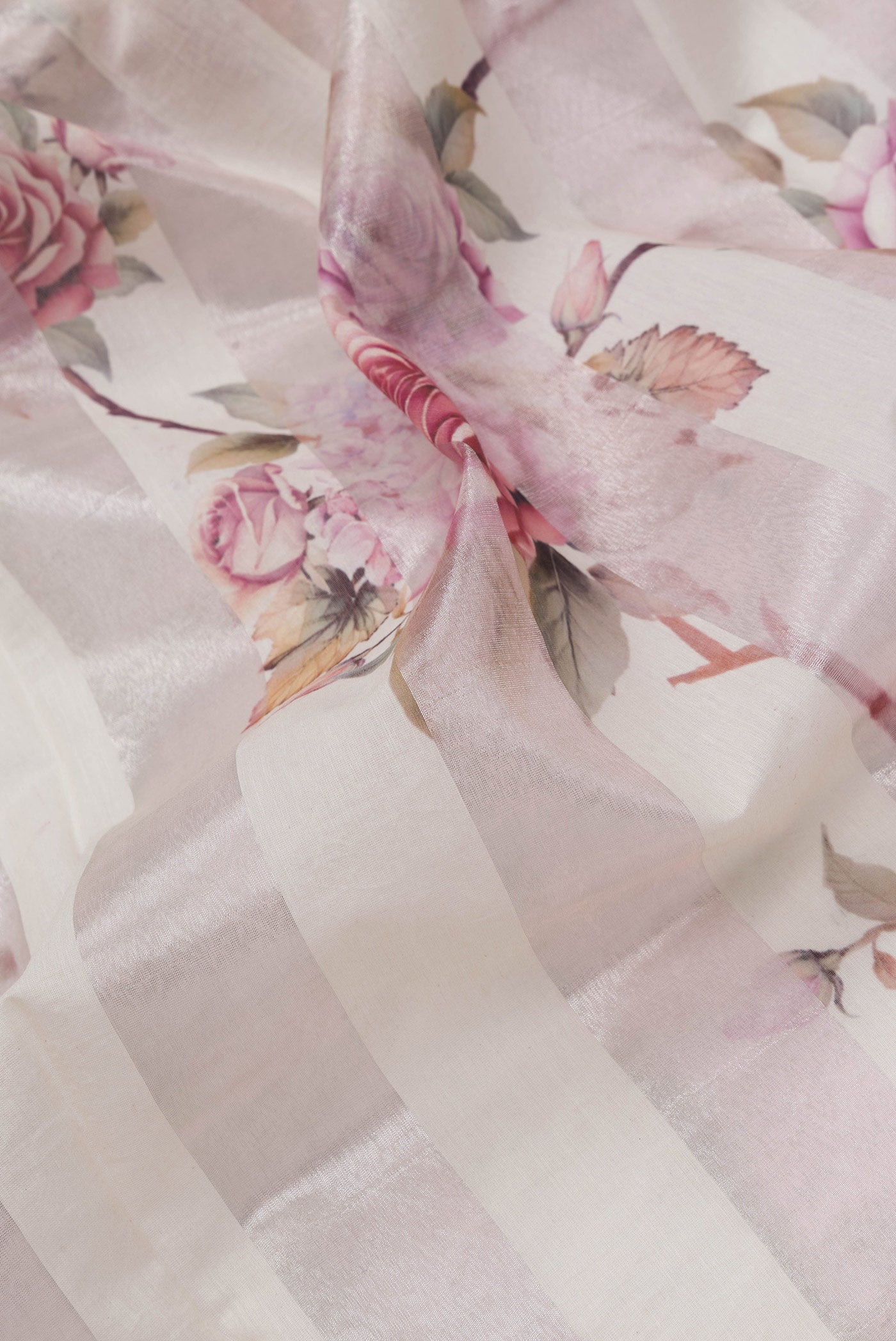 Close up of Beige Dual Tone Organza Silk Saree with Printed design on the body and Without Border.  displaying folds
