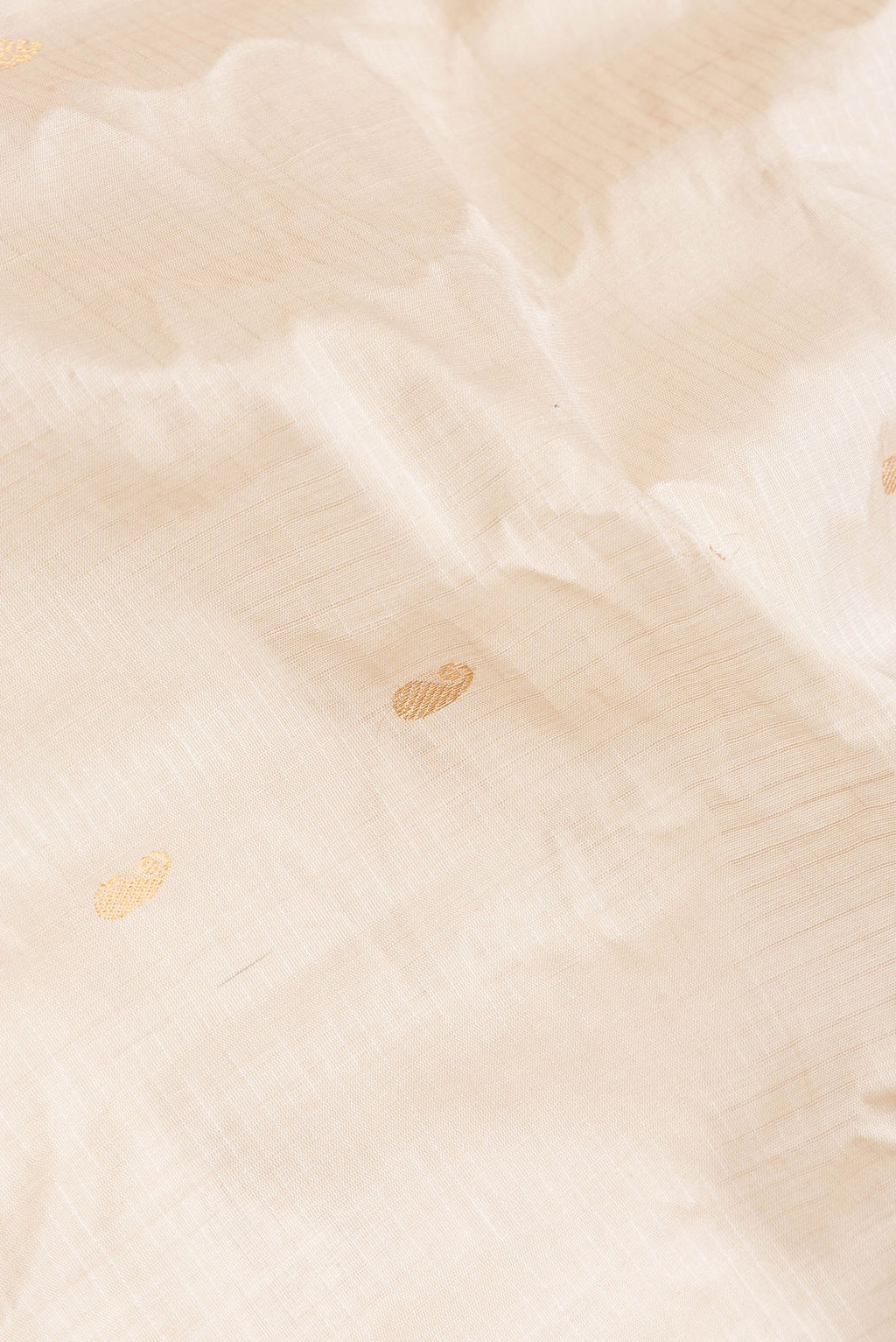 Close up of Beige Dual Tone Gadwal Silk Saree with Zari Butta on the body and Zari Border.  displaying folds