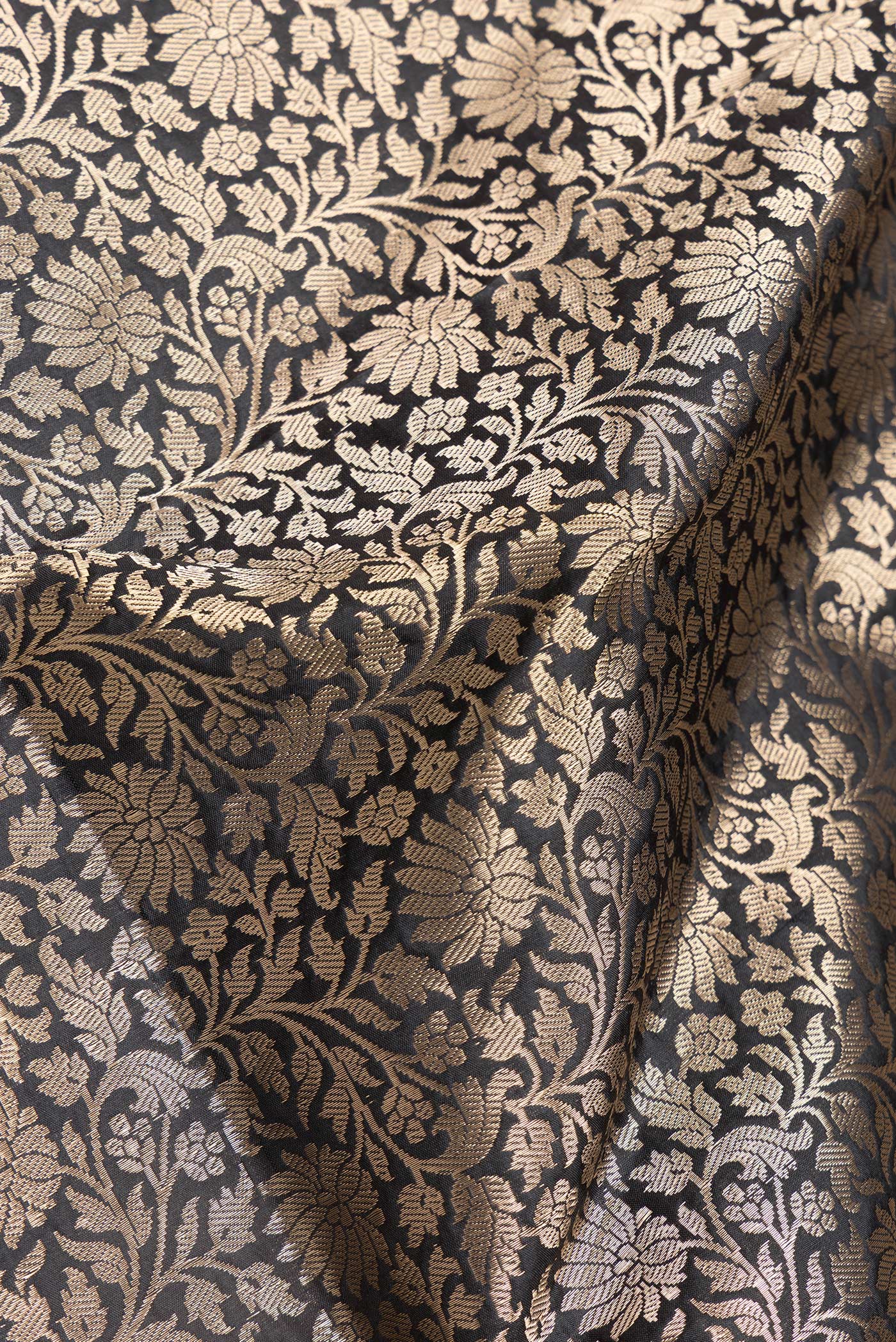 Close up of Black Dual Tone Banarasi Silk Saree with Zari Brocade on the body and Zari Border.  displaying folds