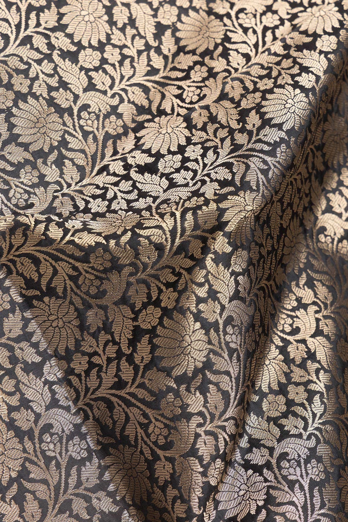 Close up of Black Dual Tone Banarasi Silk Saree with Zari Brocade on the body and Zari Border.  displaying folds