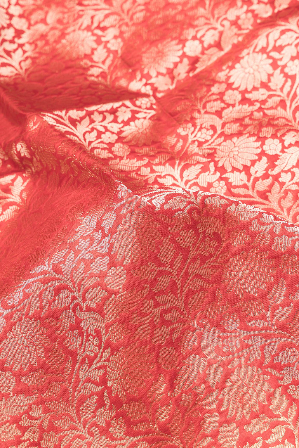 Close up of Red Dual Tone Banarasi Silk Saree with Zari Brocade on the body and Zari Border.  displaying folds