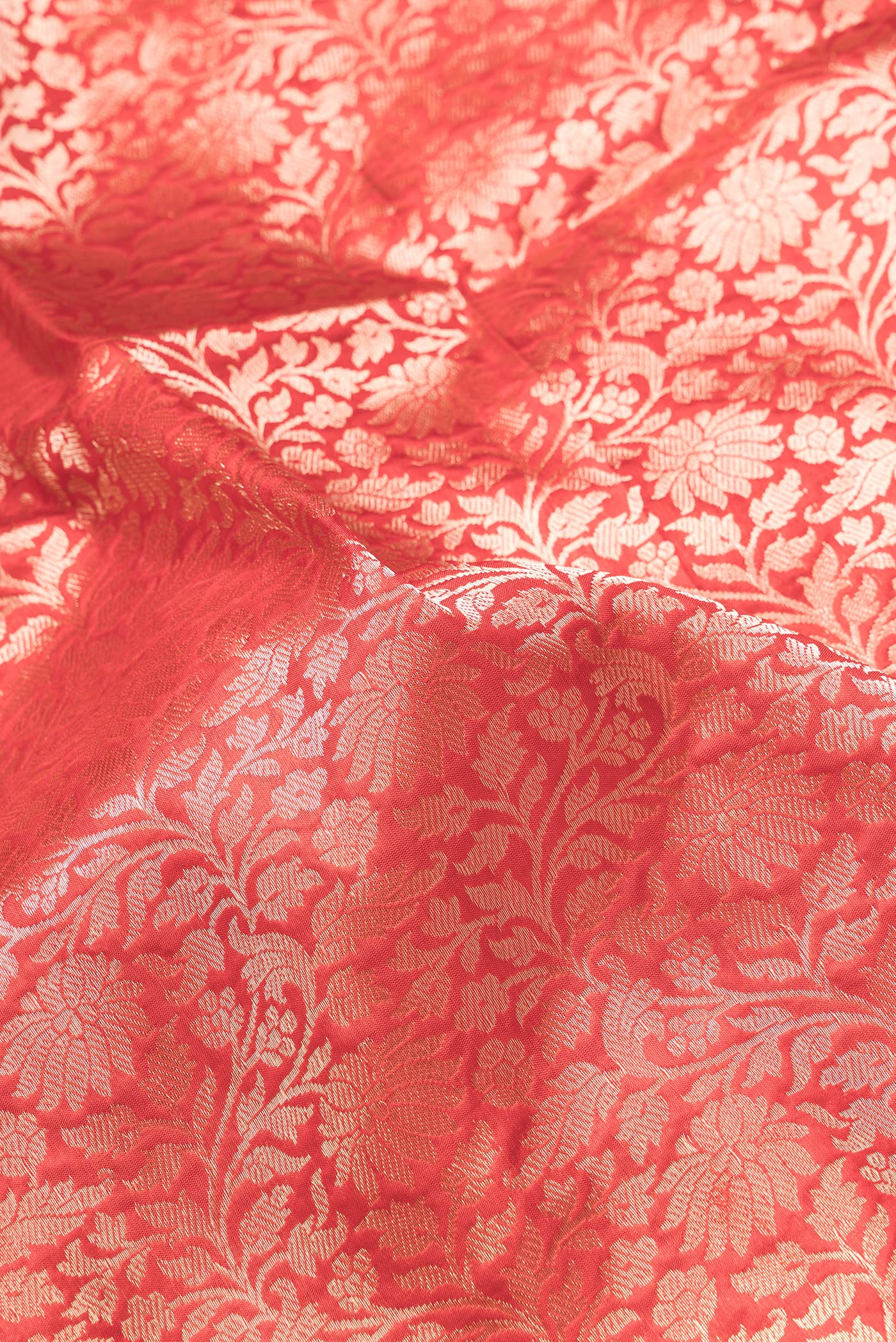 Close up of Red Dual Tone Banarasi Silk Saree with Zari Brocade on the body and Zari Border.  displaying folds