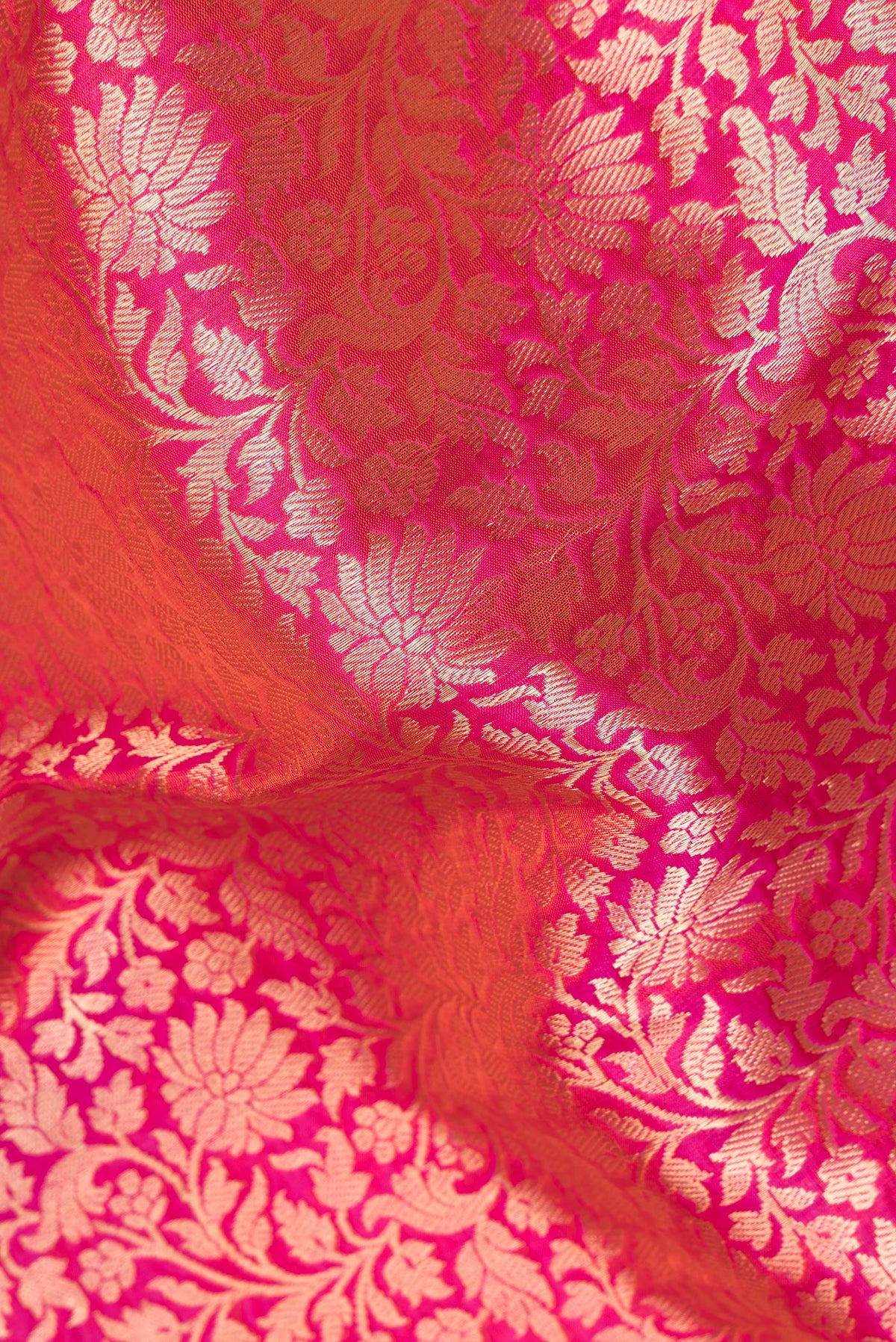 Close up of Pure Silk Coral Dual Tone Banarasi Saree with Zari Brocade on the body and Zari Border.  displaying folds
