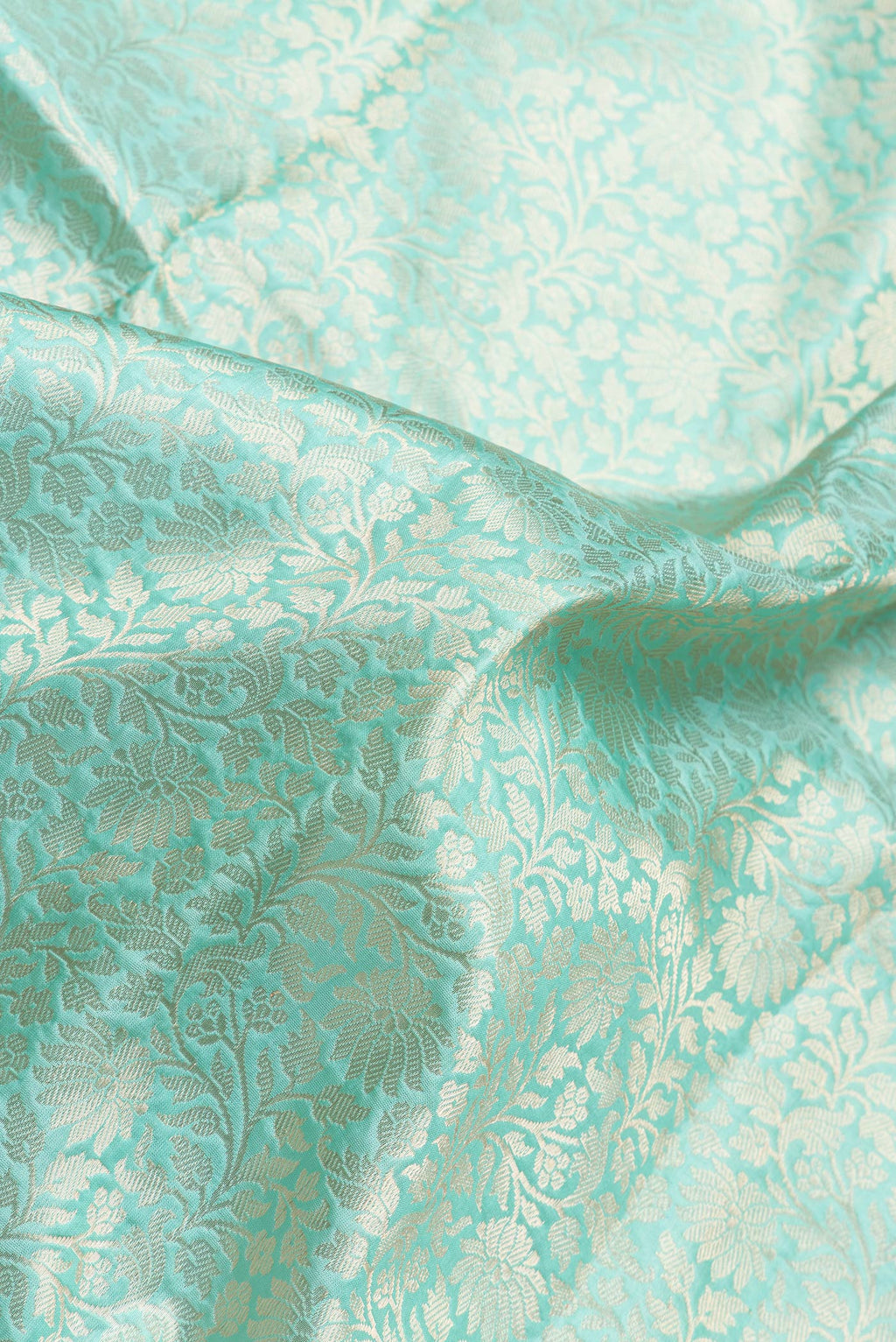 Close up of Light Blue Dual Tone Banarasi Silk Saree with Zari Brocade on the body and Zari Border.  displaying folds