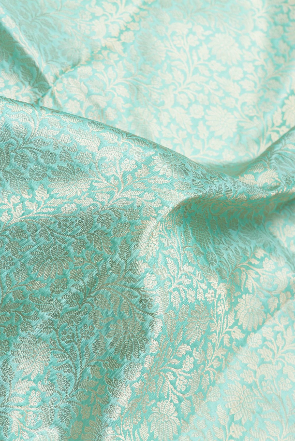 Close up of Light Blue Dual Tone Banarasi Silk Saree with Zari Brocade on the body and Zari Border.  displaying folds