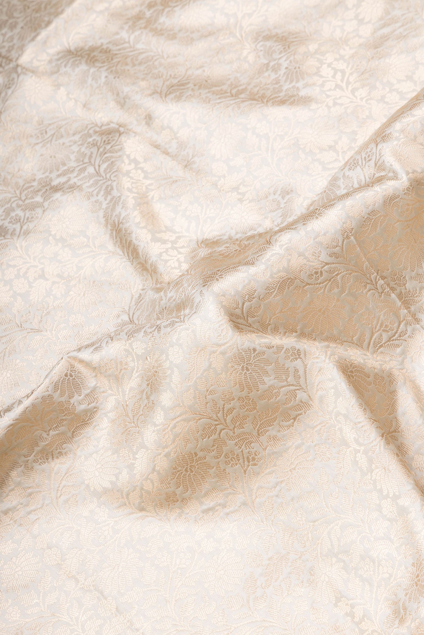 Close up of Beige Dual Tone Banarasi Silk Saree with Zari Brocade on the body and Zari Border.  displaying folds