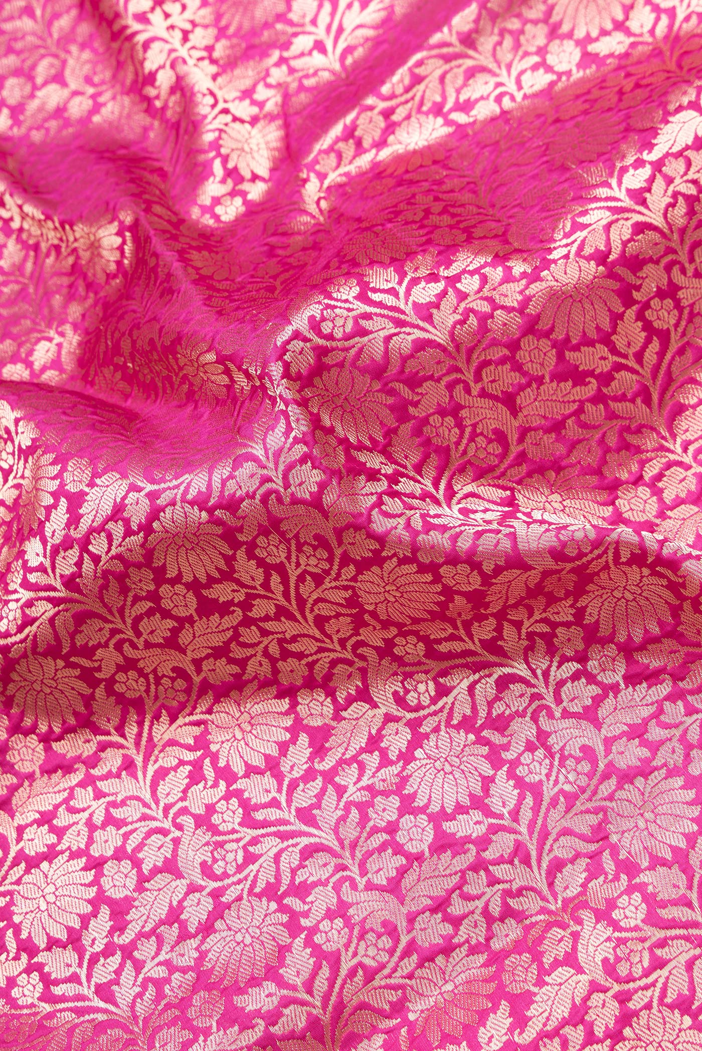 Close up of Dark Pink Dual Tone Banarasi Silk Saree with Zari Brocade on the body and Zari Border.  displaying folds