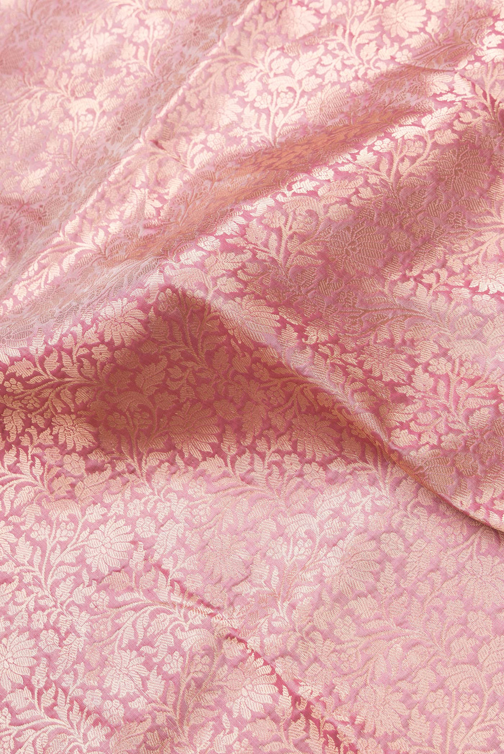 Close up of Golden Peach Dual Tone Banarasi Silk Saree with Zari Brocade on the body and Zari Border.  displaying folds