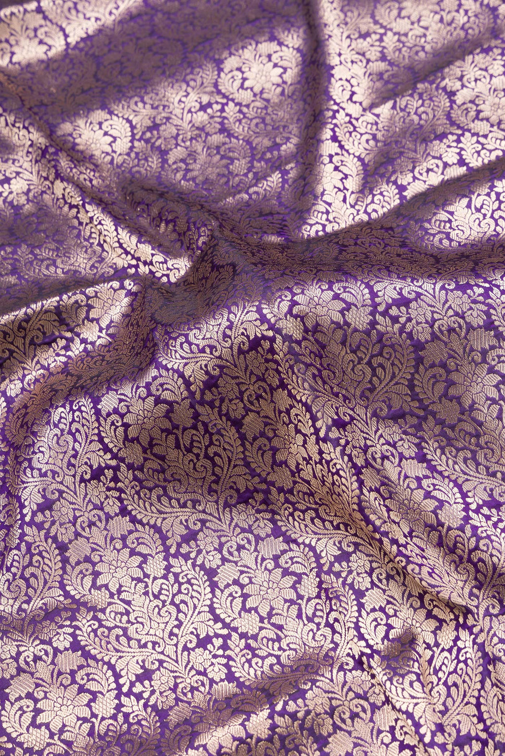 Close up of Violet Dual Tone Banarasi Silk Saree with Zari Brocade on the body and Zari Border.  displaying folds