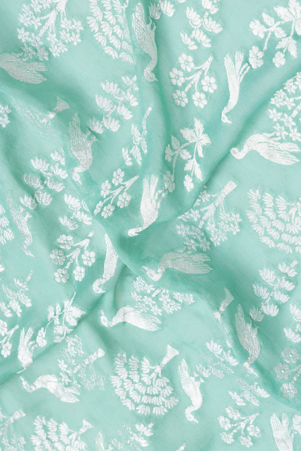 Close up of Sea Green Dual Tone Banarasi Georgette Saree with Zari Brocade on the body and Zari Border.  displaying folds