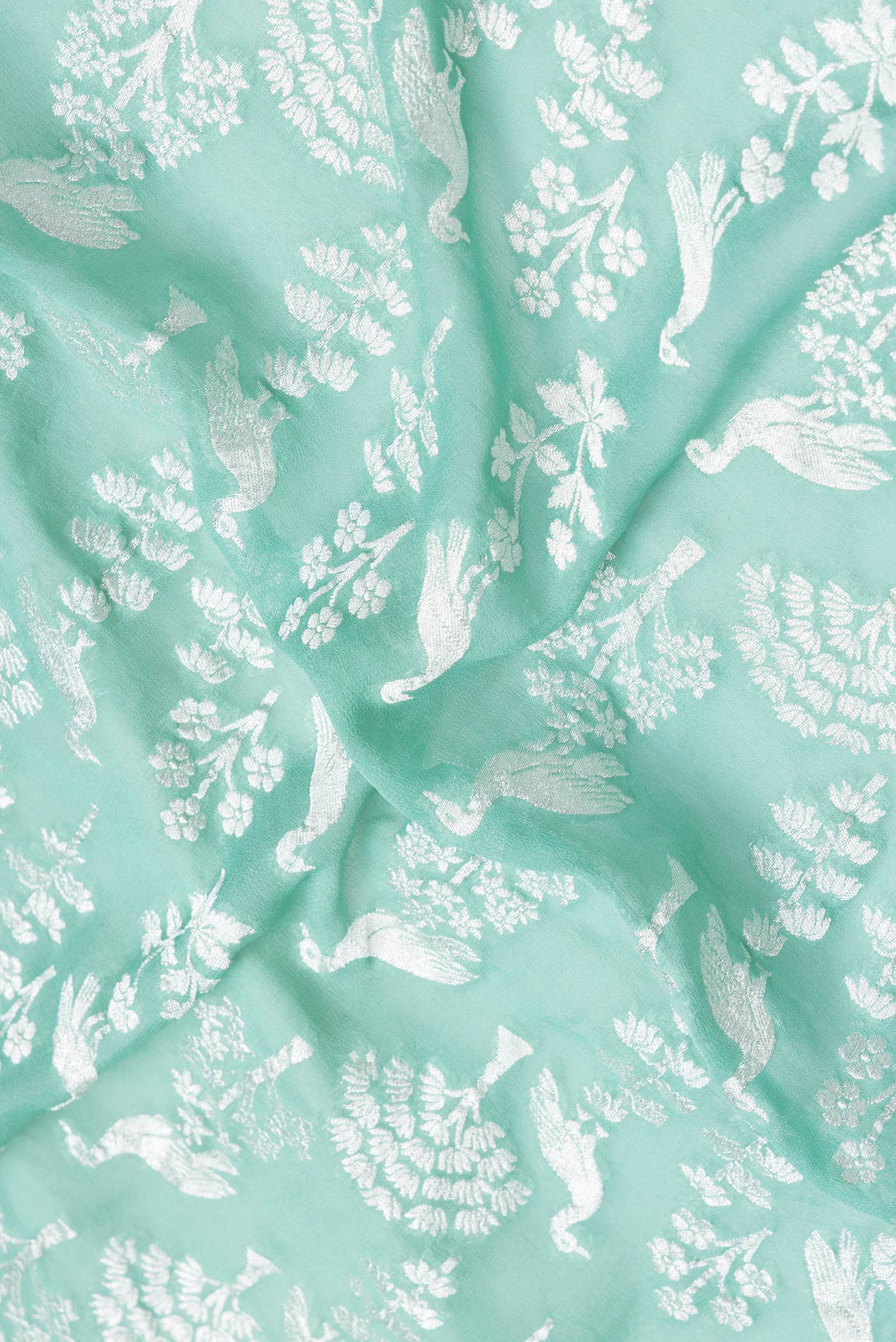 Close up of Sea Green Dual Tone Banarasi Georgette Saree with Zari Brocade on the body and Zari Border.  displaying folds
