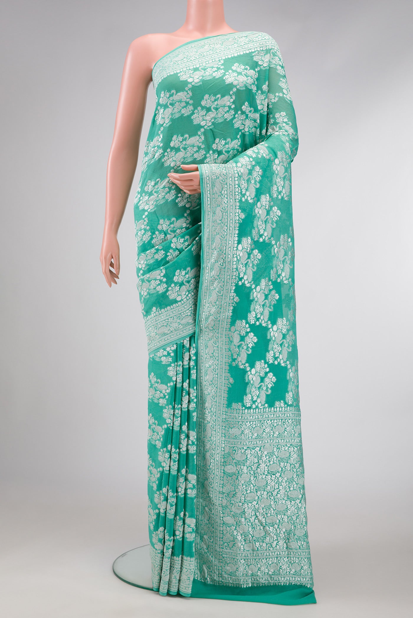 Sea Green Dual Tone Mysore Georgette Saree with Zari Brocade on the body and Zari Border.  displayed on a mannequin