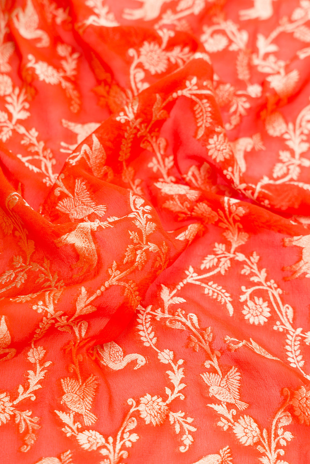Close up of Orange Dual Tone Mysore Georgette Saree with Zari Brocade on the body and Zari Border.  displaying folds