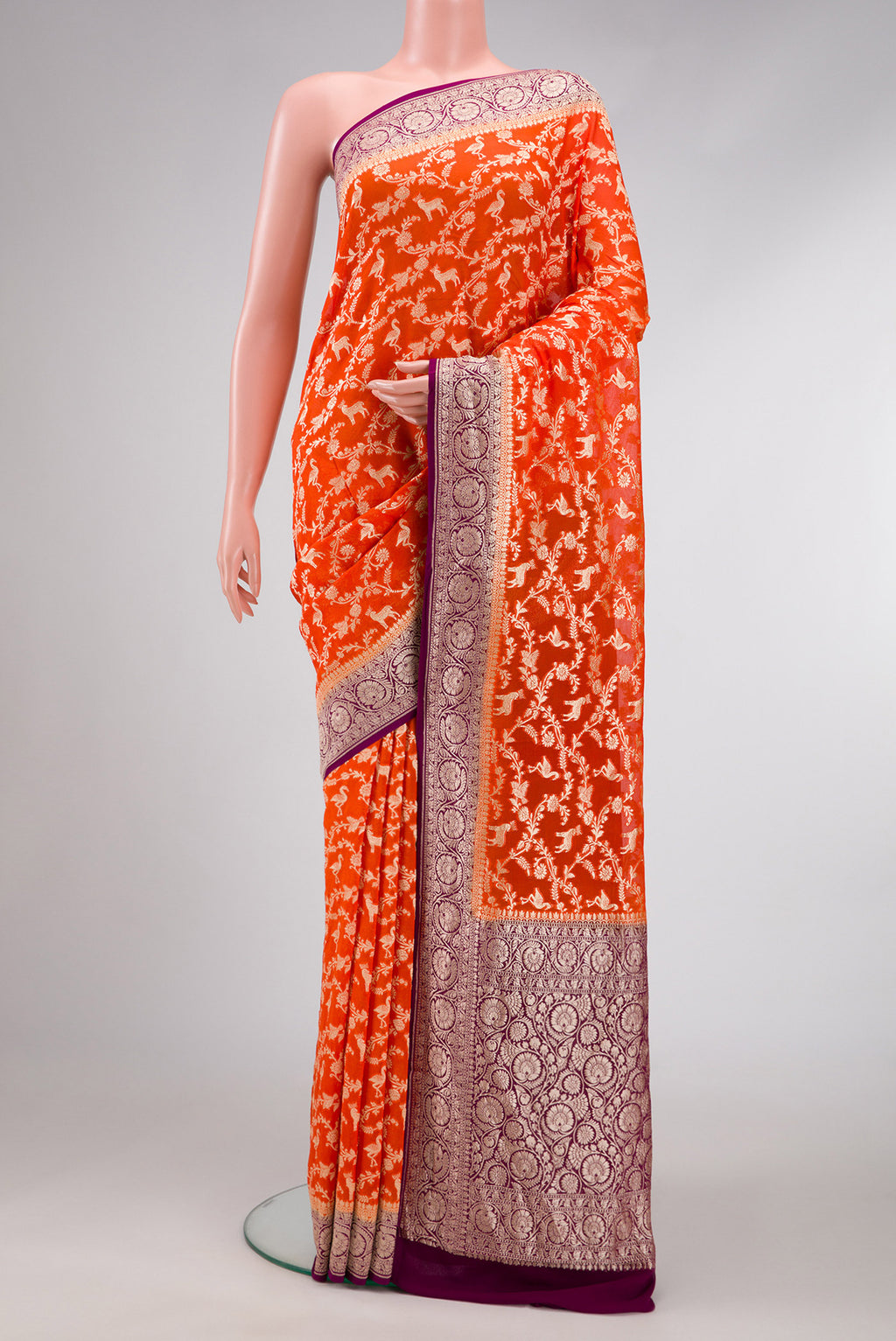 Orange Dual Tone Mysore Georgette Saree with Zari Brocade on the body and Zari Border.  displayed on a mannequin