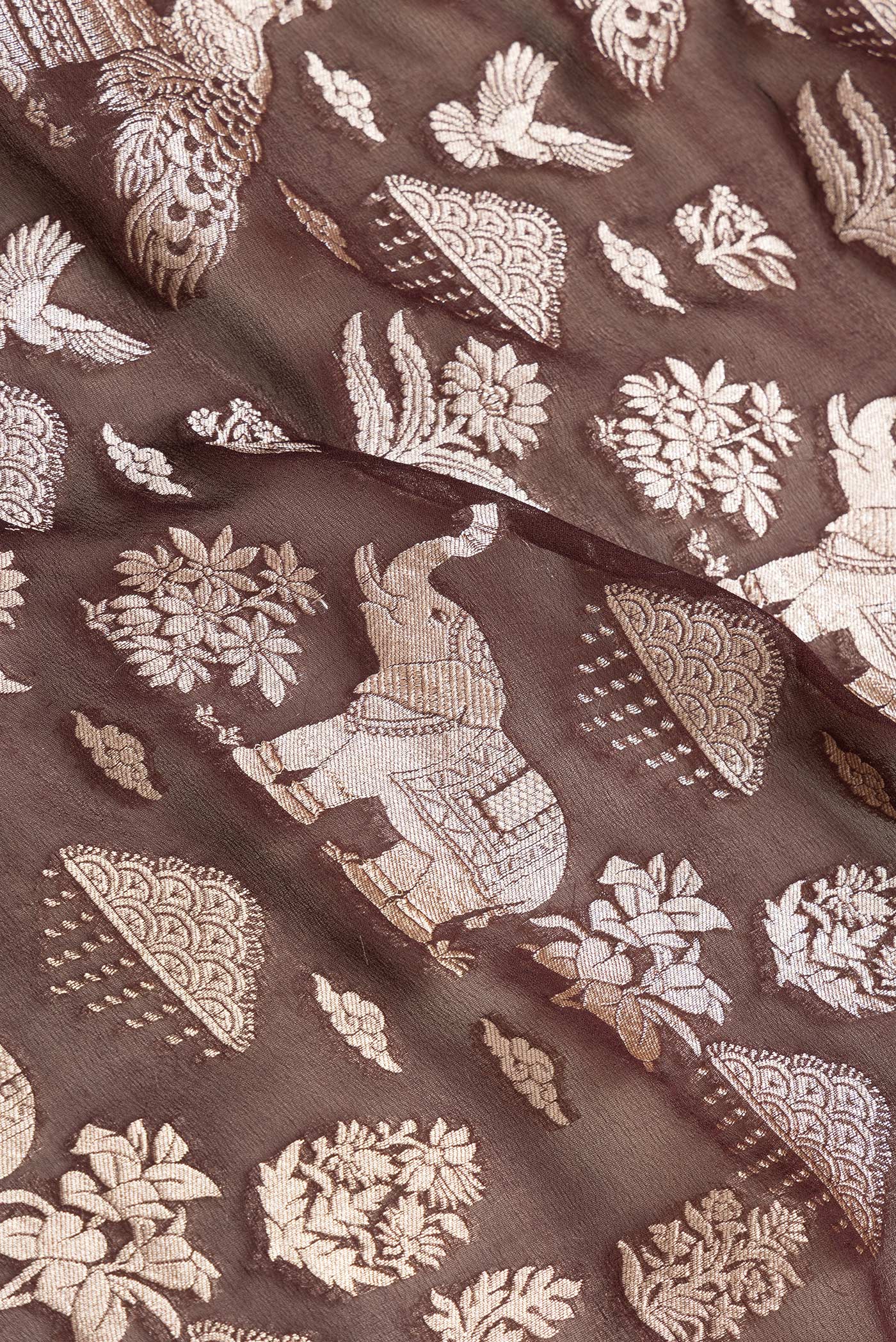 Close up of Brown Dual Tone Banarasi Georgette Saree with Zari Brocade on the body and Zari Border.  displaying folds