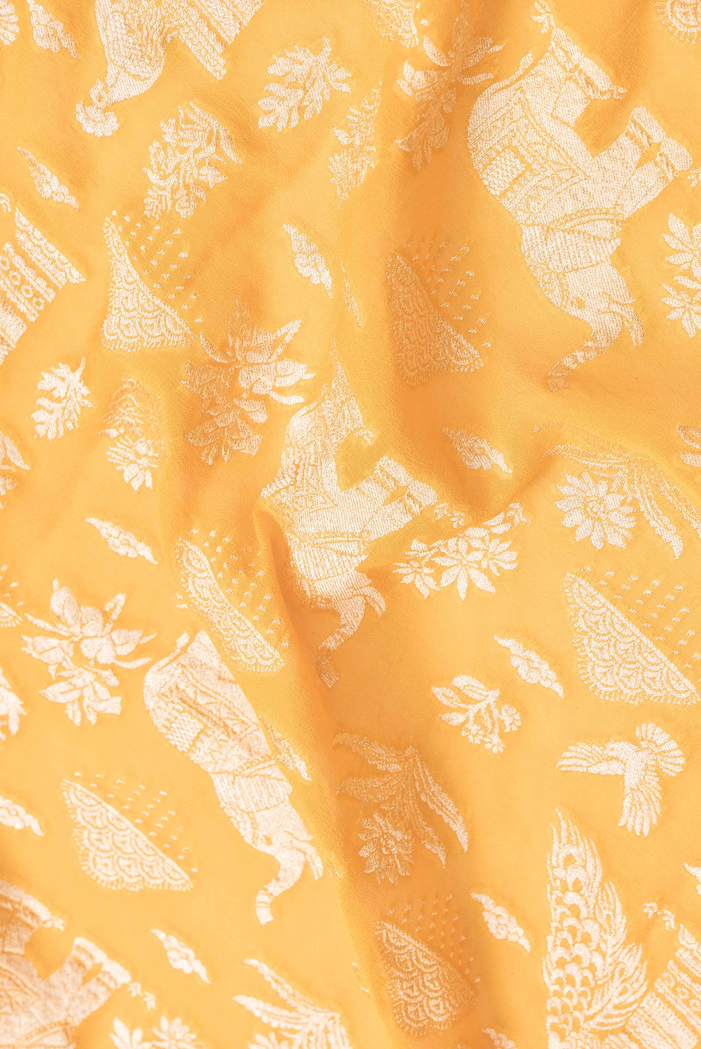 Close up of Yellow Dual Tone Banarasi Georgette Saree with Zari Brocade on the body and Fancy Border.  displaying folds