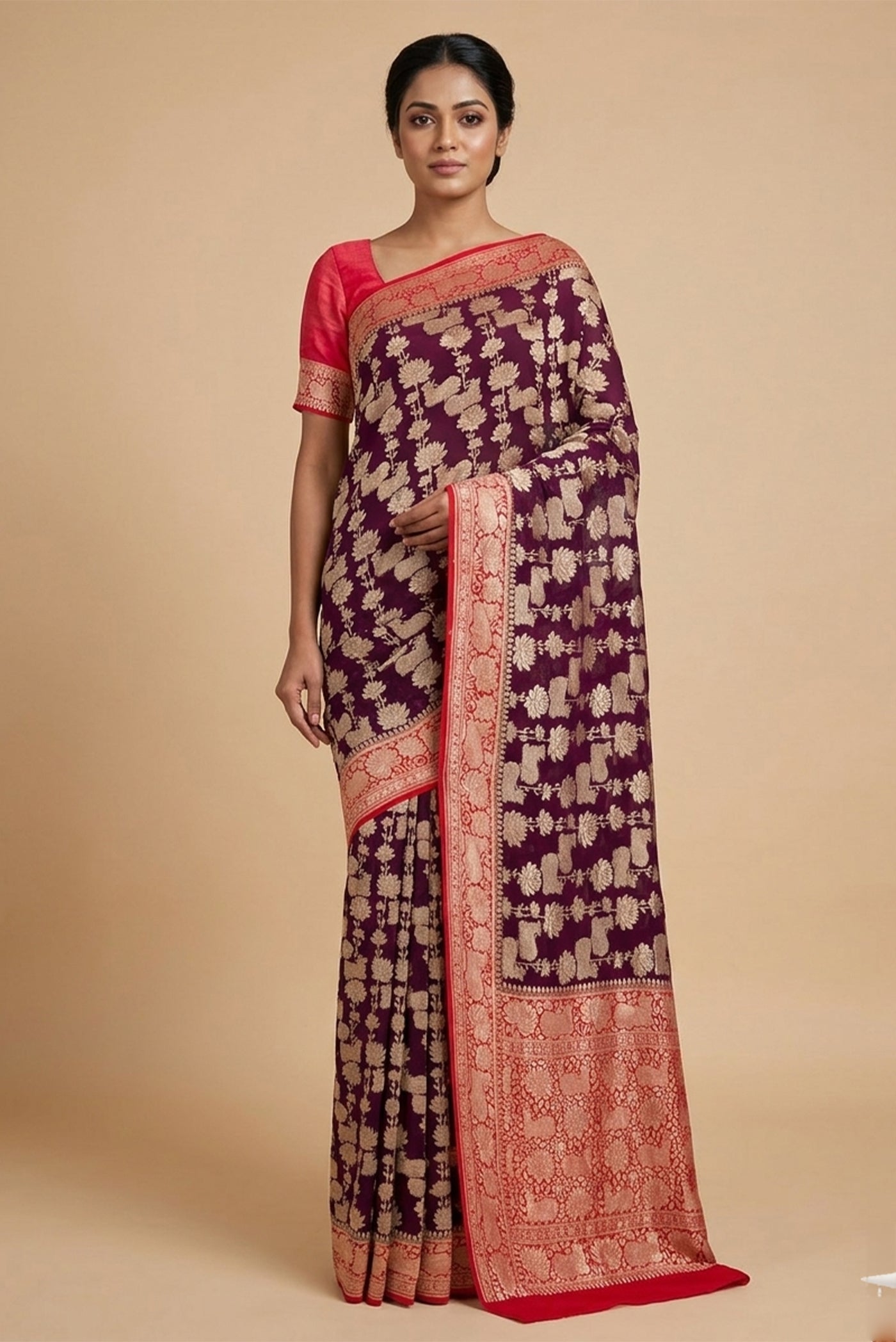 Model wearing a Burgundy Banarasi Georgette Saree with Zari Brocade on the body and Zari Border.