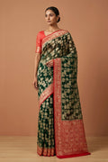 Model wearing a Bottle Green Banarasi Georgette Saree with Zari Brocade on the body and Zari Border.