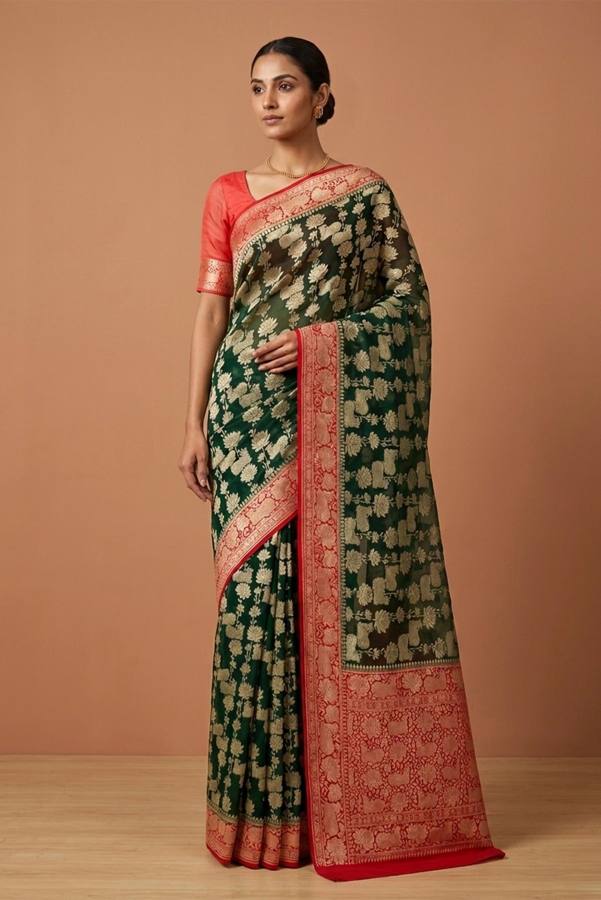 Model wearing a Bottle Green Banarasi Georgette Saree with Zari Brocade on the body and Zari Border.