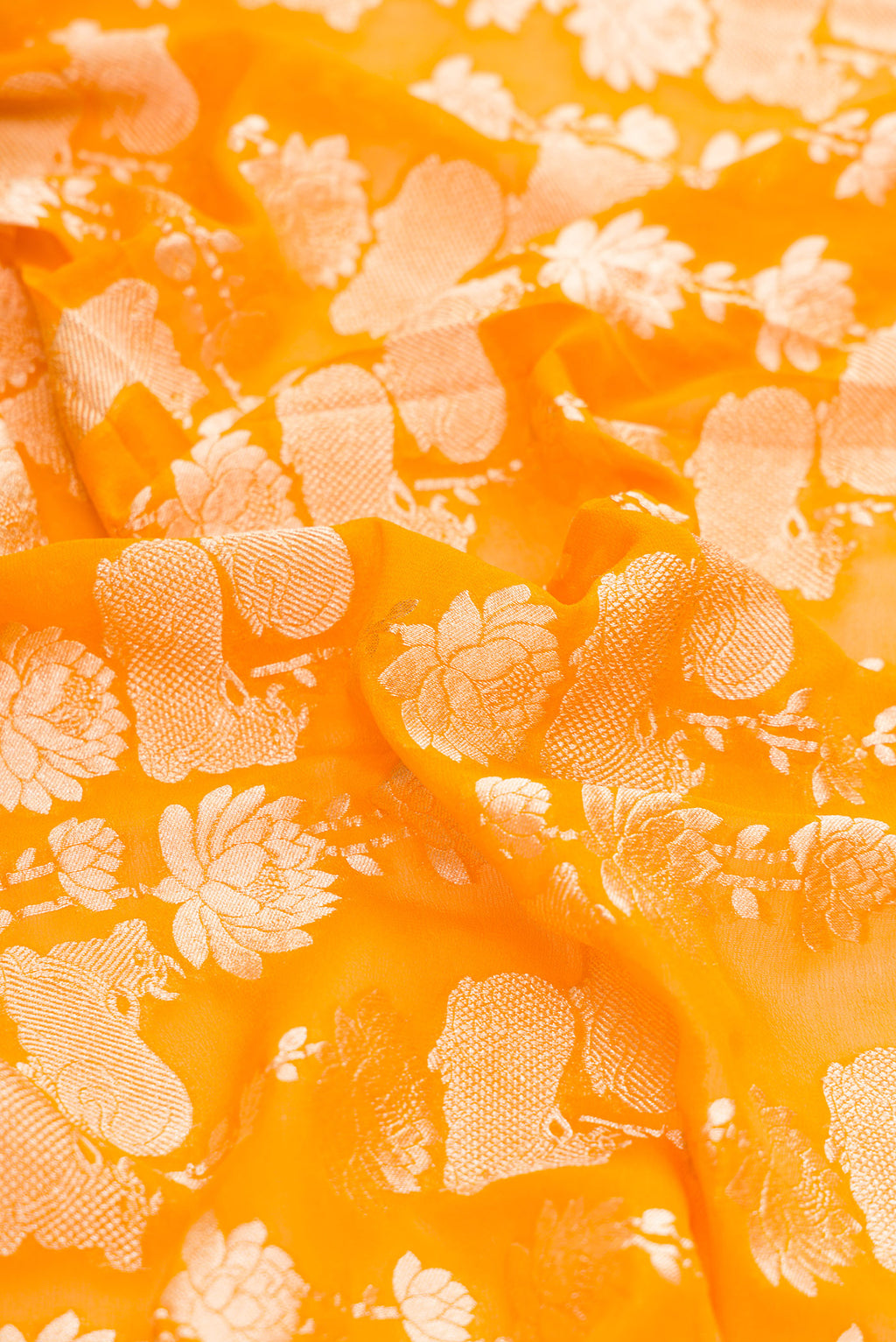 Close up of Mustard Dual Tone Mysore Georgette Saree with Zari Brocade on the body and Zari Border.  displaying folds