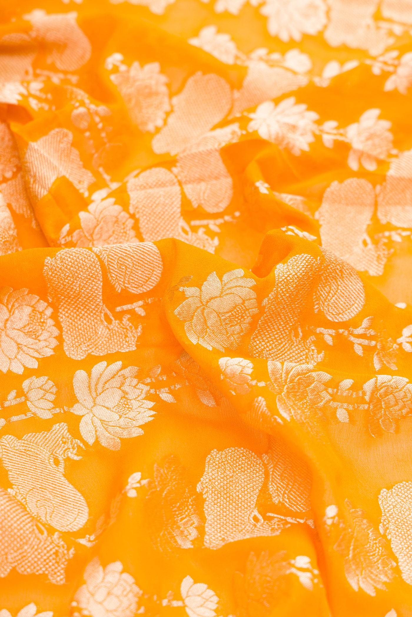 Close up of Mustard Dual Tone Mysore Georgette Saree with Zari Brocade on the body and Zari Border.  displaying folds