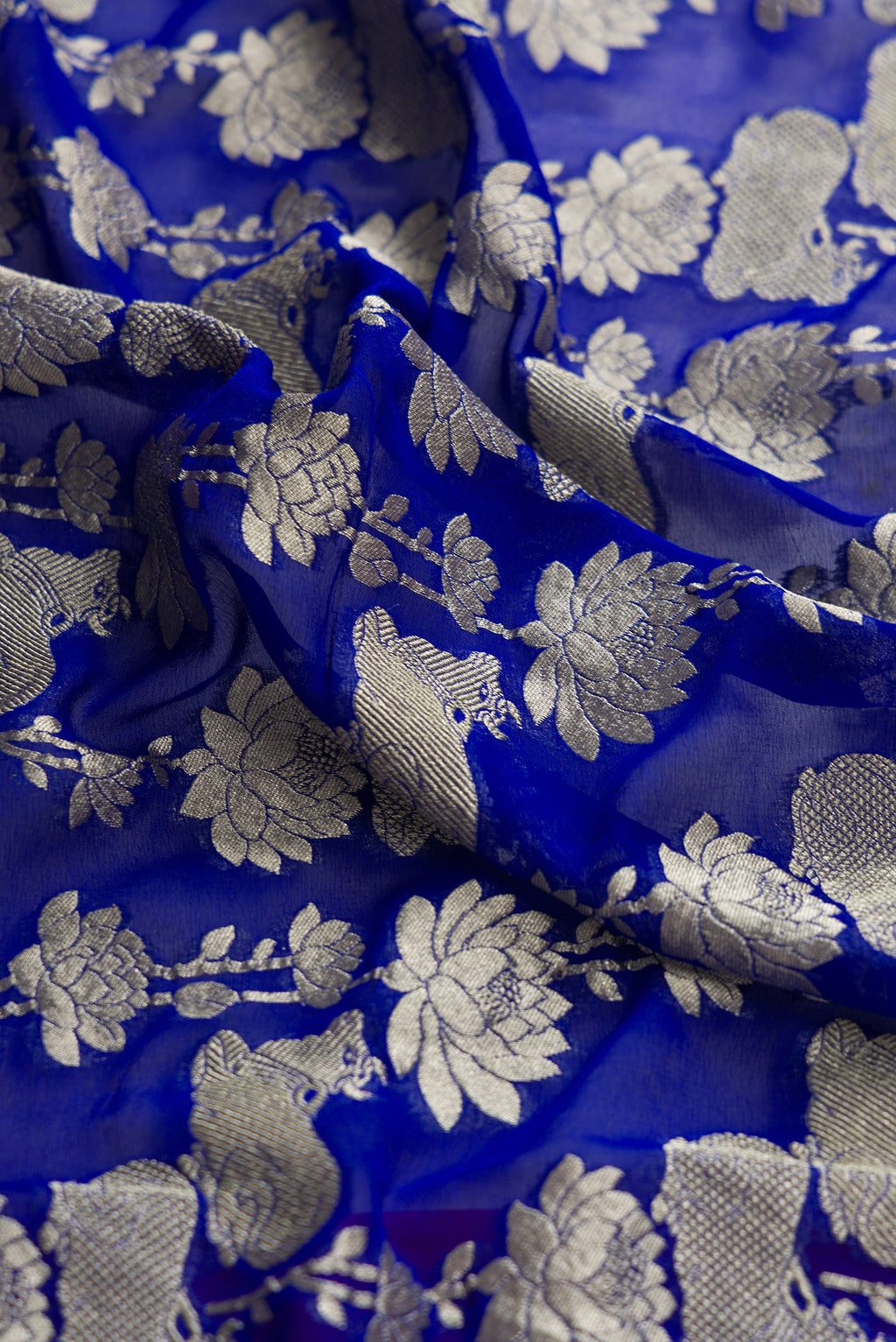 Close up of Royal Blue Dual Tone Mysore Georgette Saree with Zari Brocade on the body and Zari Border.  displaying folds