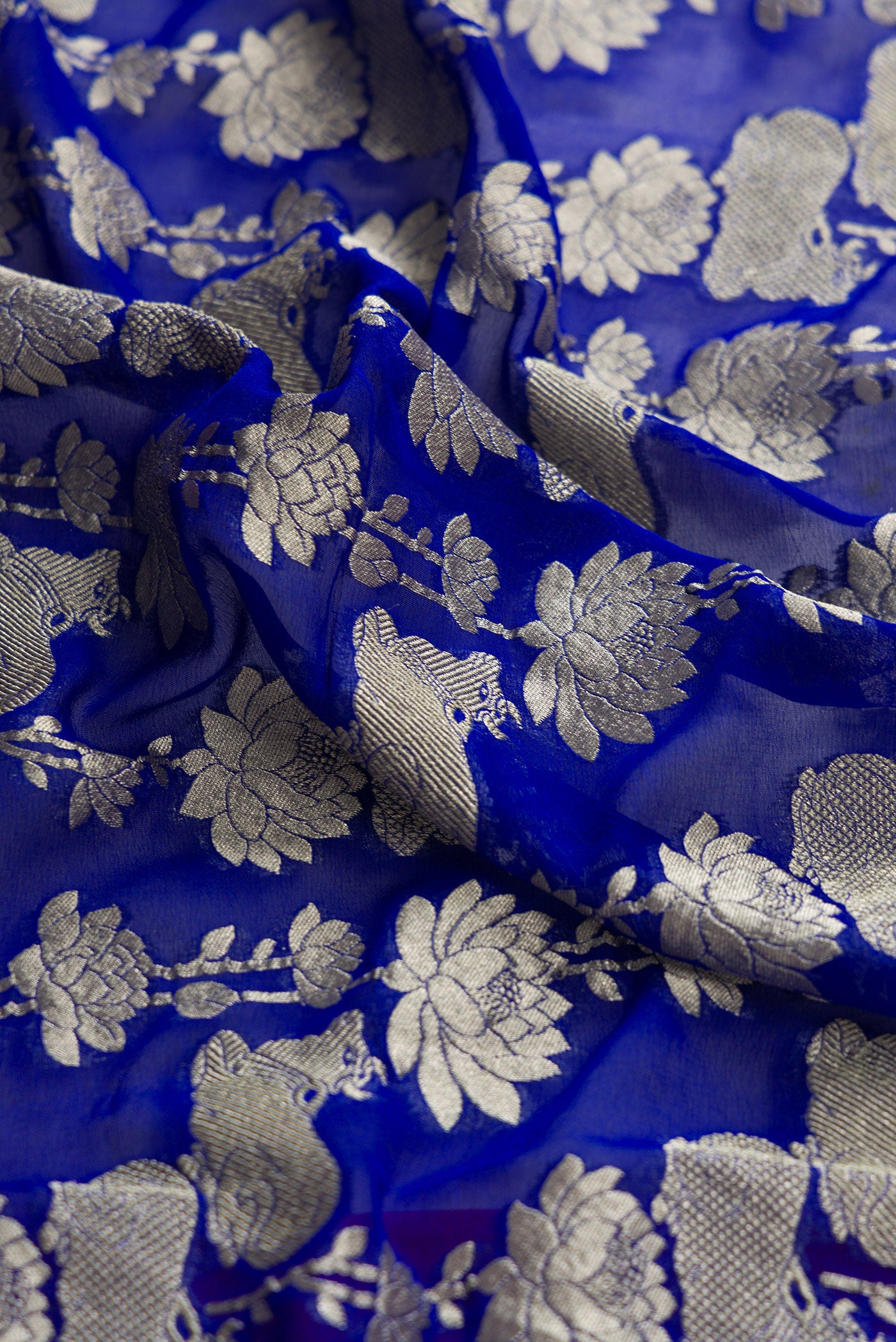 Close up of Royal Blue Dual Tone Mysore Georgette Saree with Zari Brocade on the body and Zari Border.  displaying folds