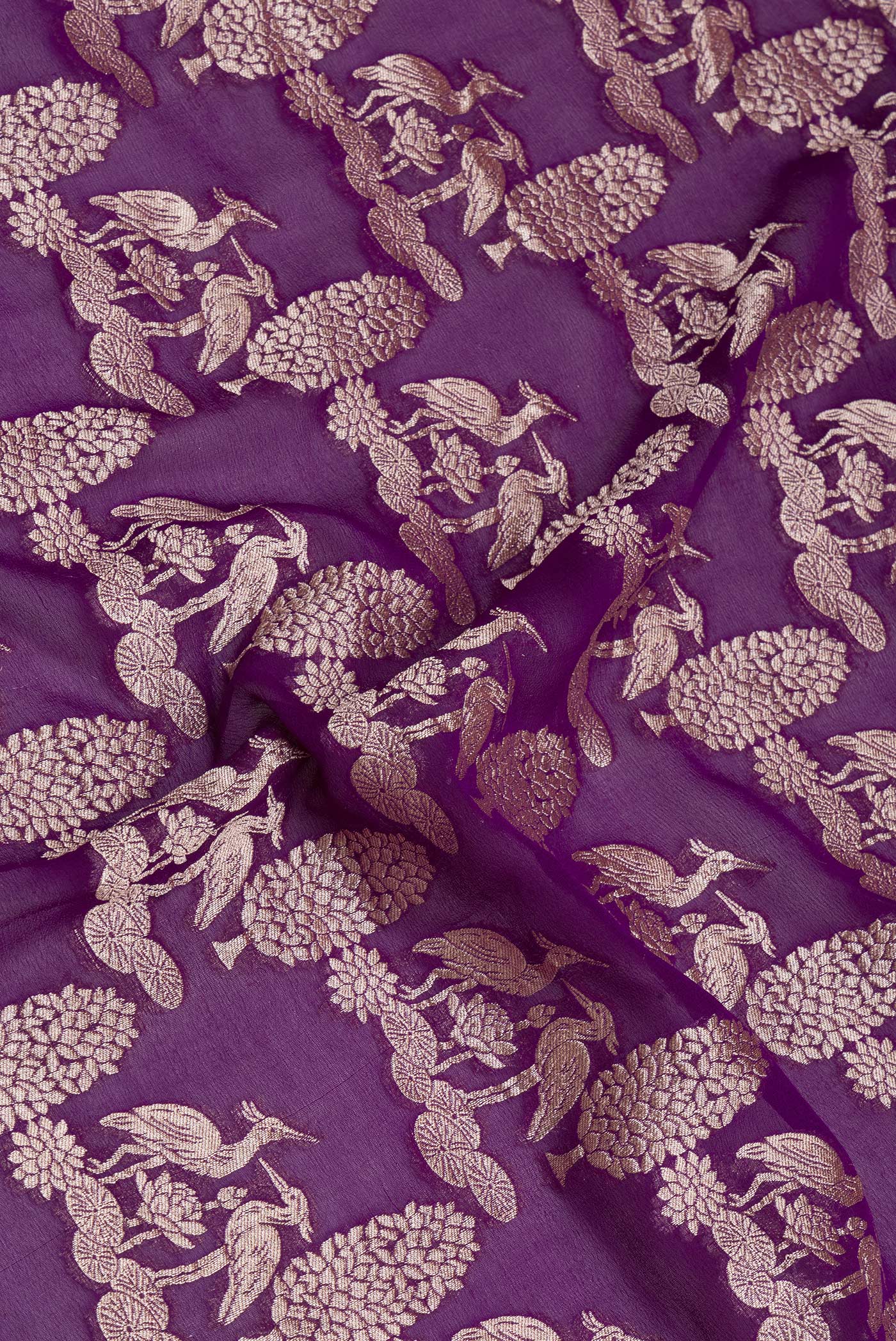 Close up of Violet Banarasi Georgette Saree with Zari Brocade on the body and Zari Border.  displaying folds