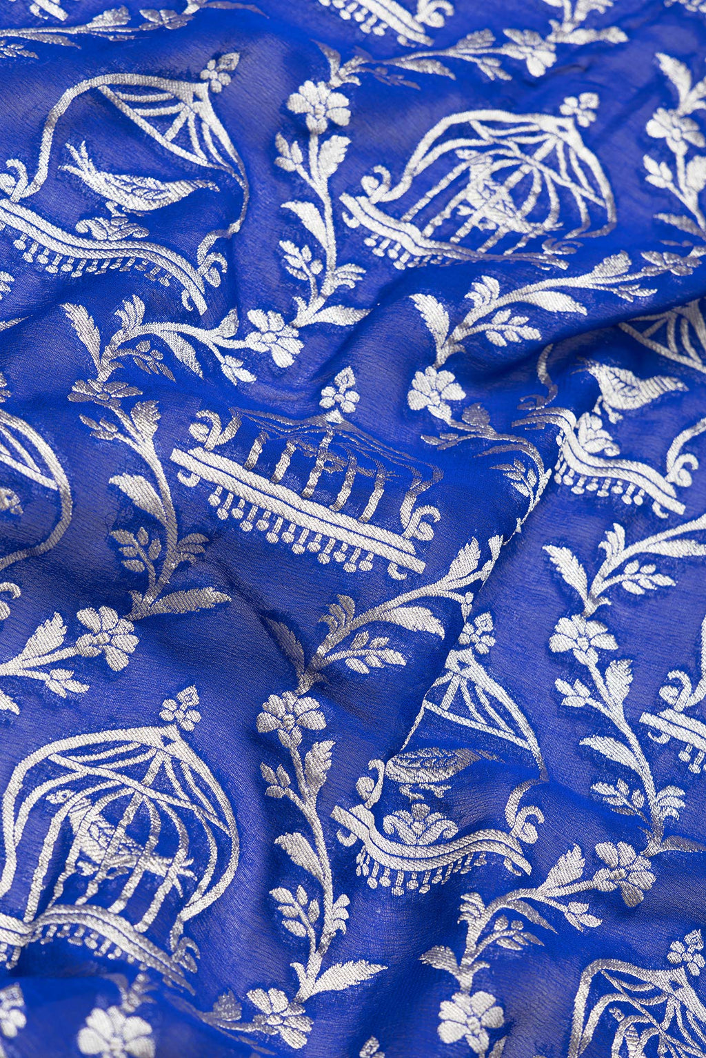 Close up of Royal Blue Dual Tone Banarasi Georgette Saree with Zari Brocade on the body and Zari Border.  displaying folds